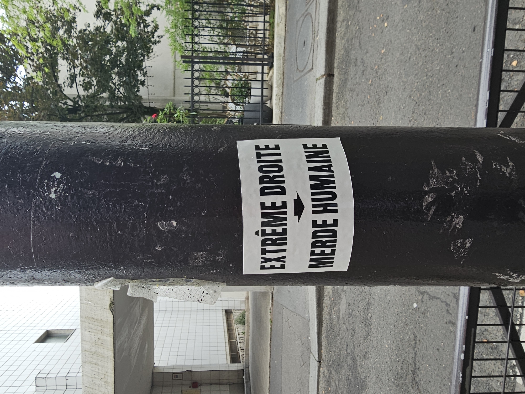Political sticker spotted on Paris street bollard