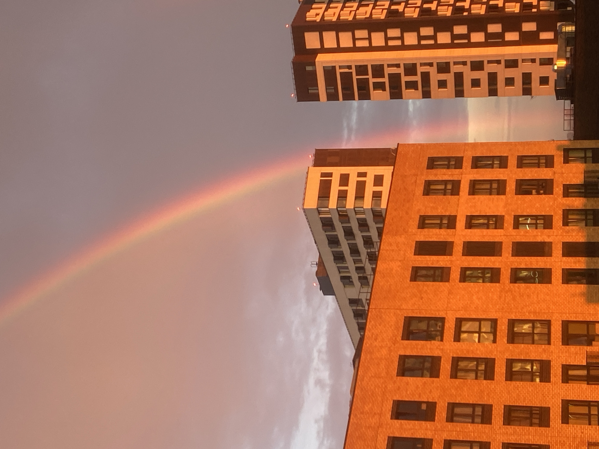 Rainbow and golden sunset over Moscow high-rises
