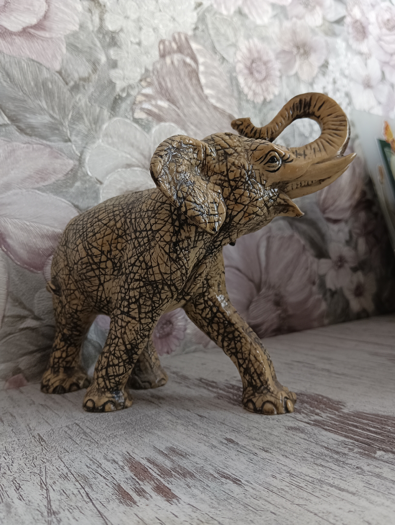 Three decorative elephant figurines on display, each with distinct style