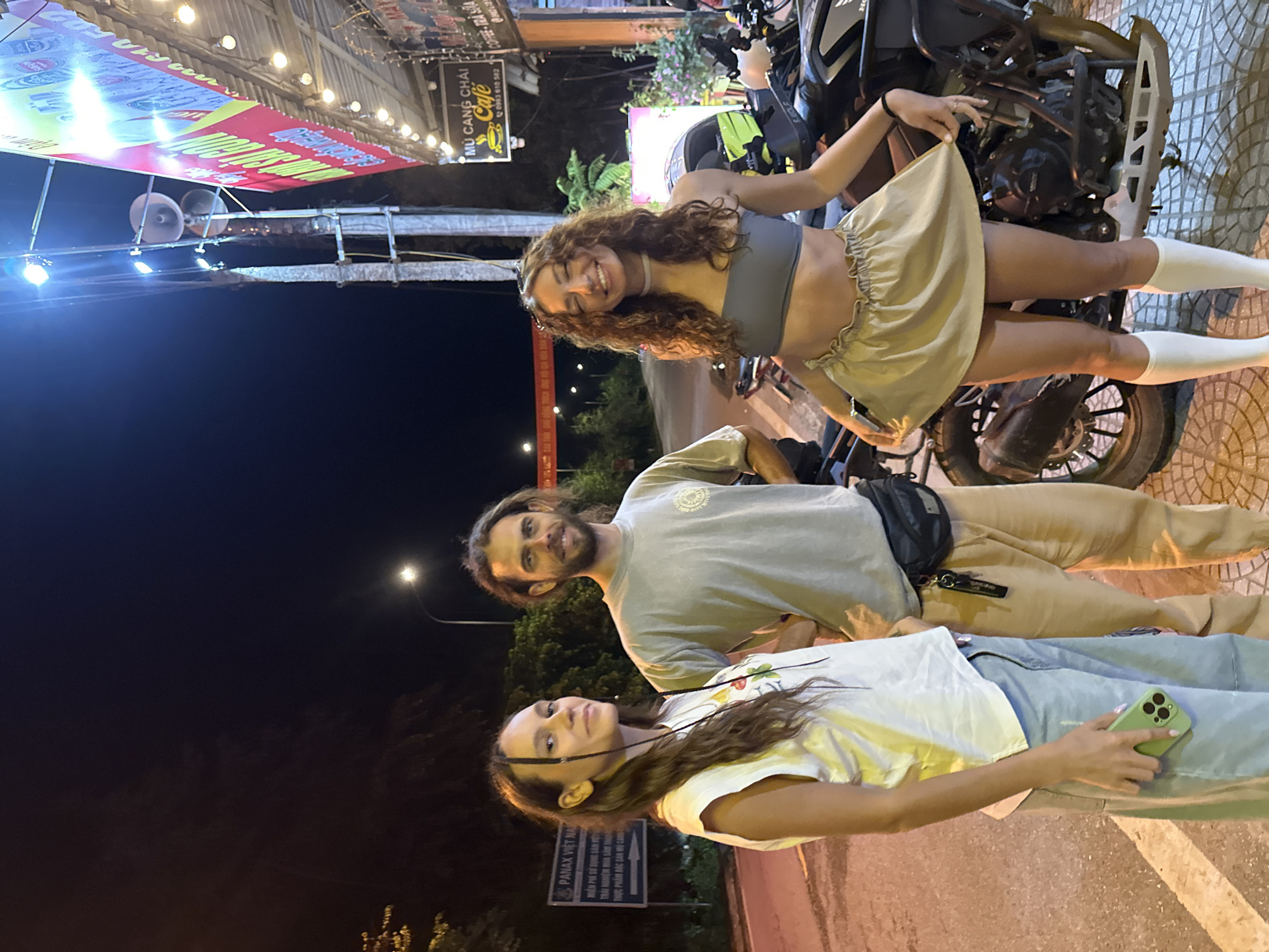 Friends pose for nighttime photos on Mù Cang Chải street