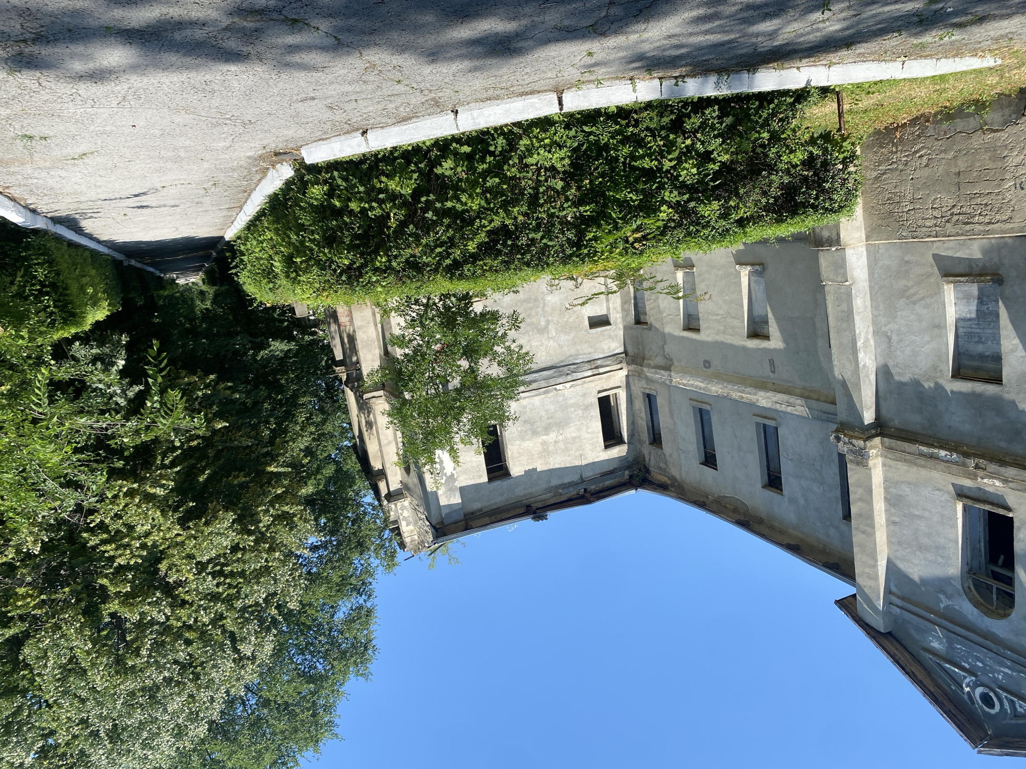 Crumbling park paths and an abandoned building in Codru, Moldova