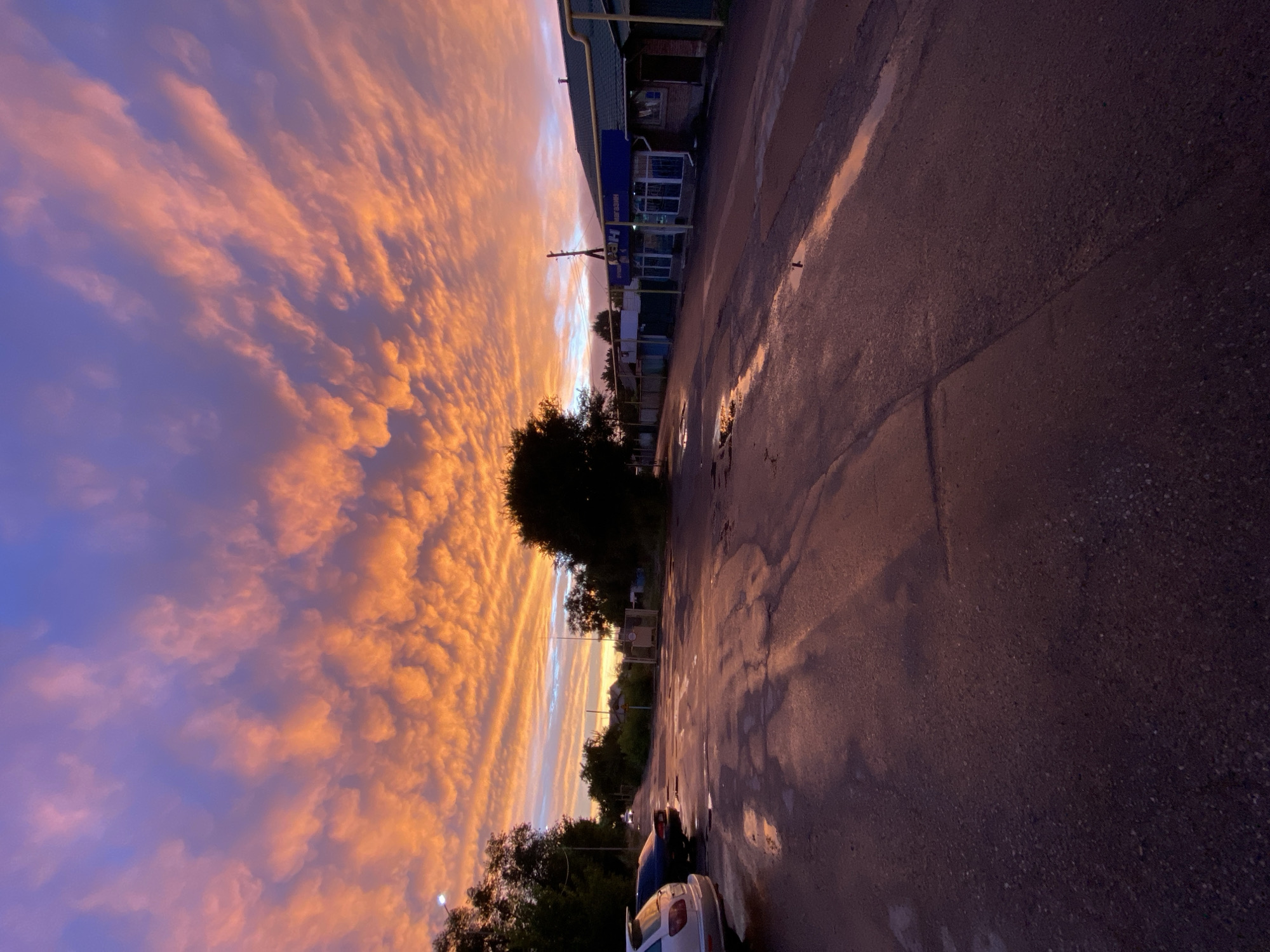 Tekeli streets glow under a fiery post-rain sunset