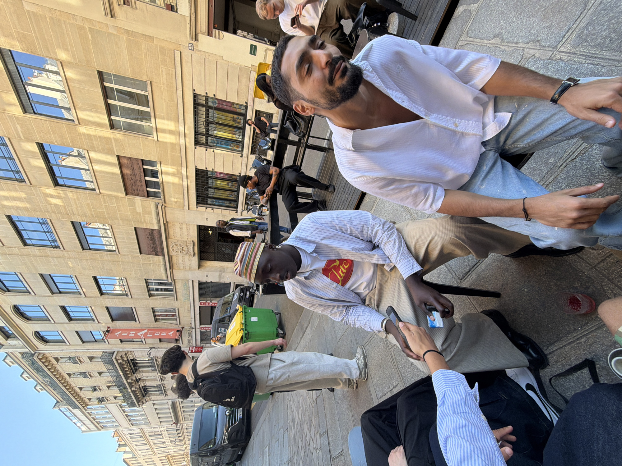 Parisians gather at outdoor tables for afternoon conversations