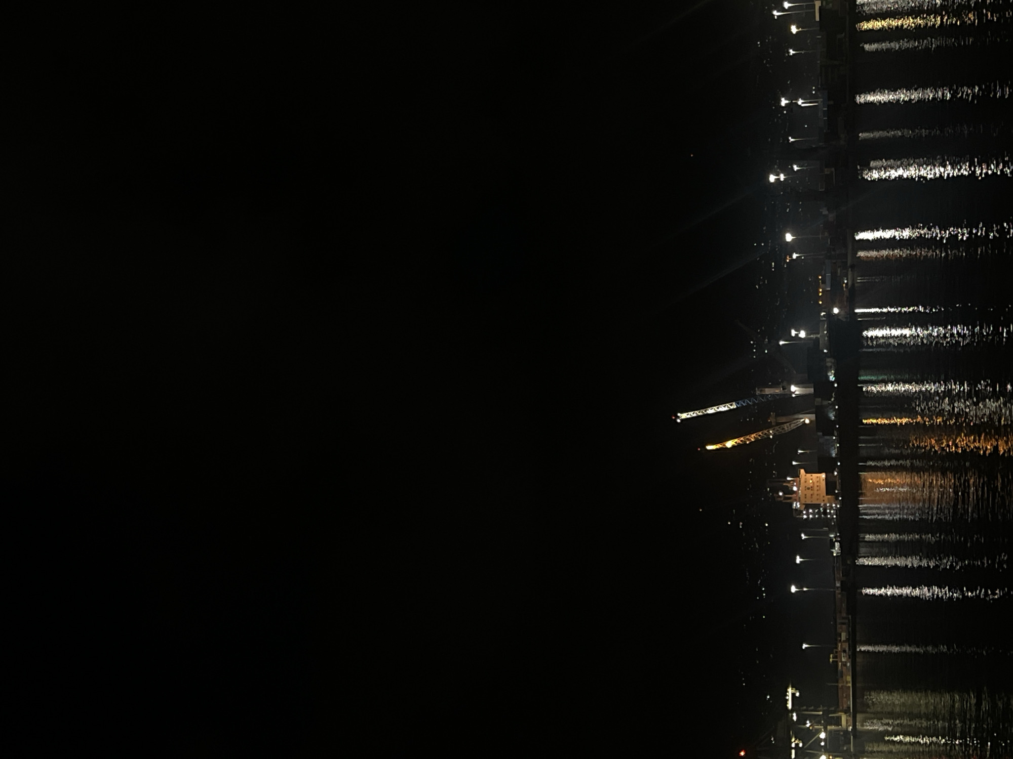 Nighttime crane and pier activity documented by witnesses
