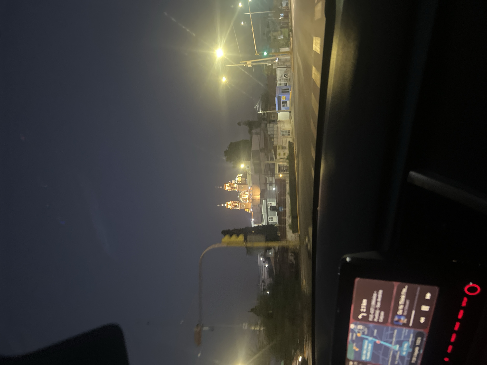 Nighttime view of illuminated Cholula church captured from vehicle