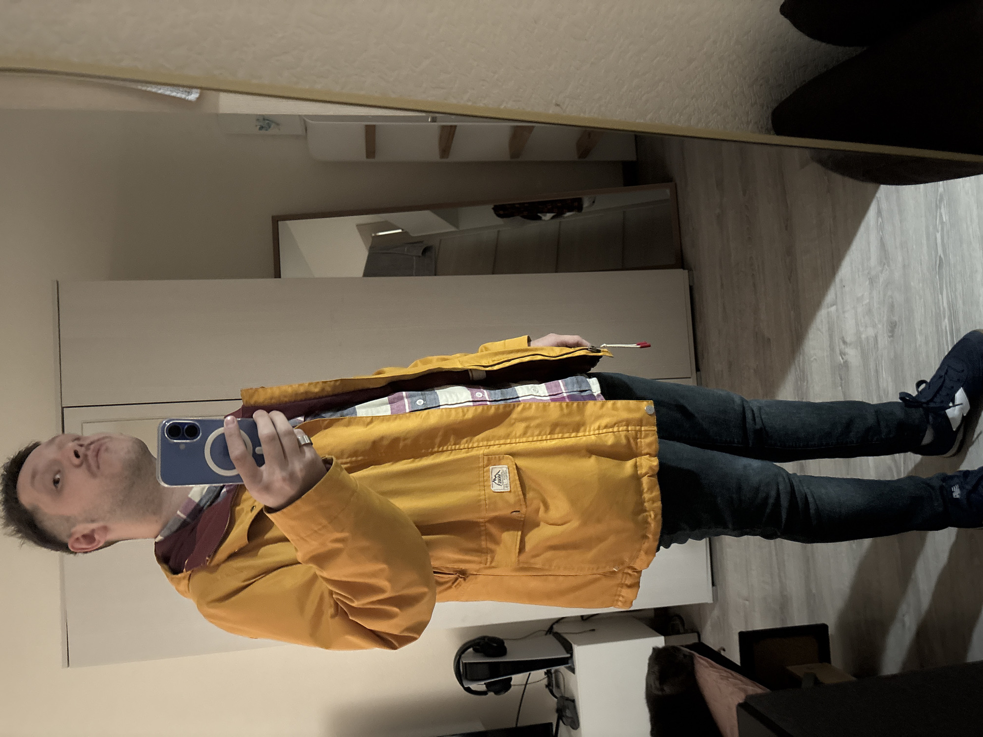 Man takes mirror selfie in yellow jacket, Saint Petersburg