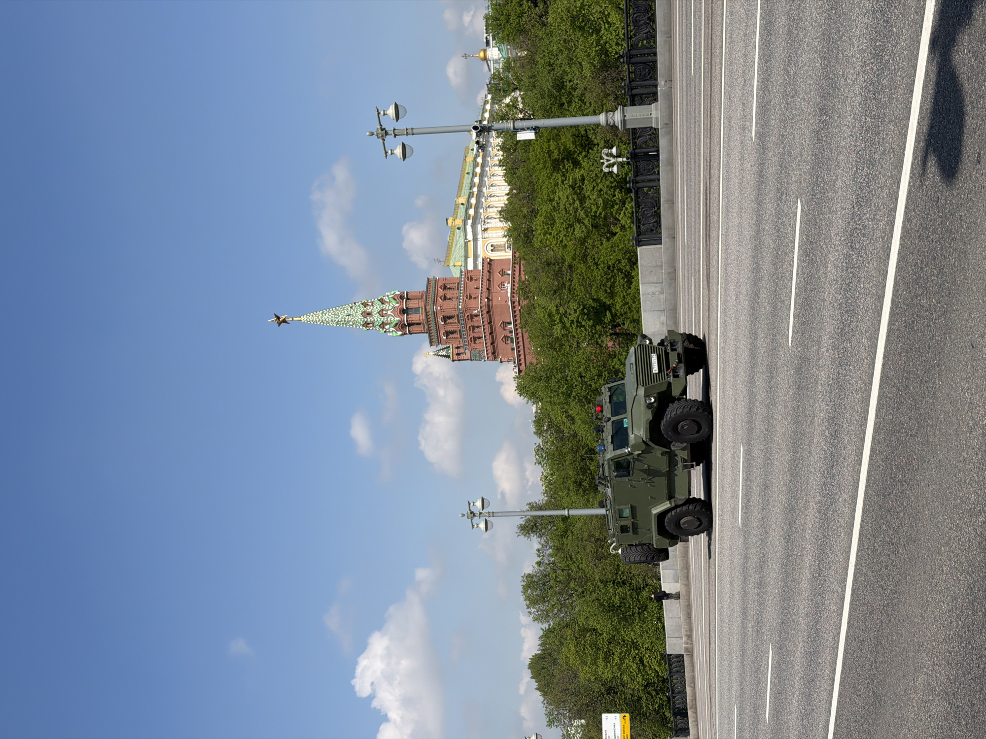 Military vehicles spotted on urban streets alongside civilian traffic