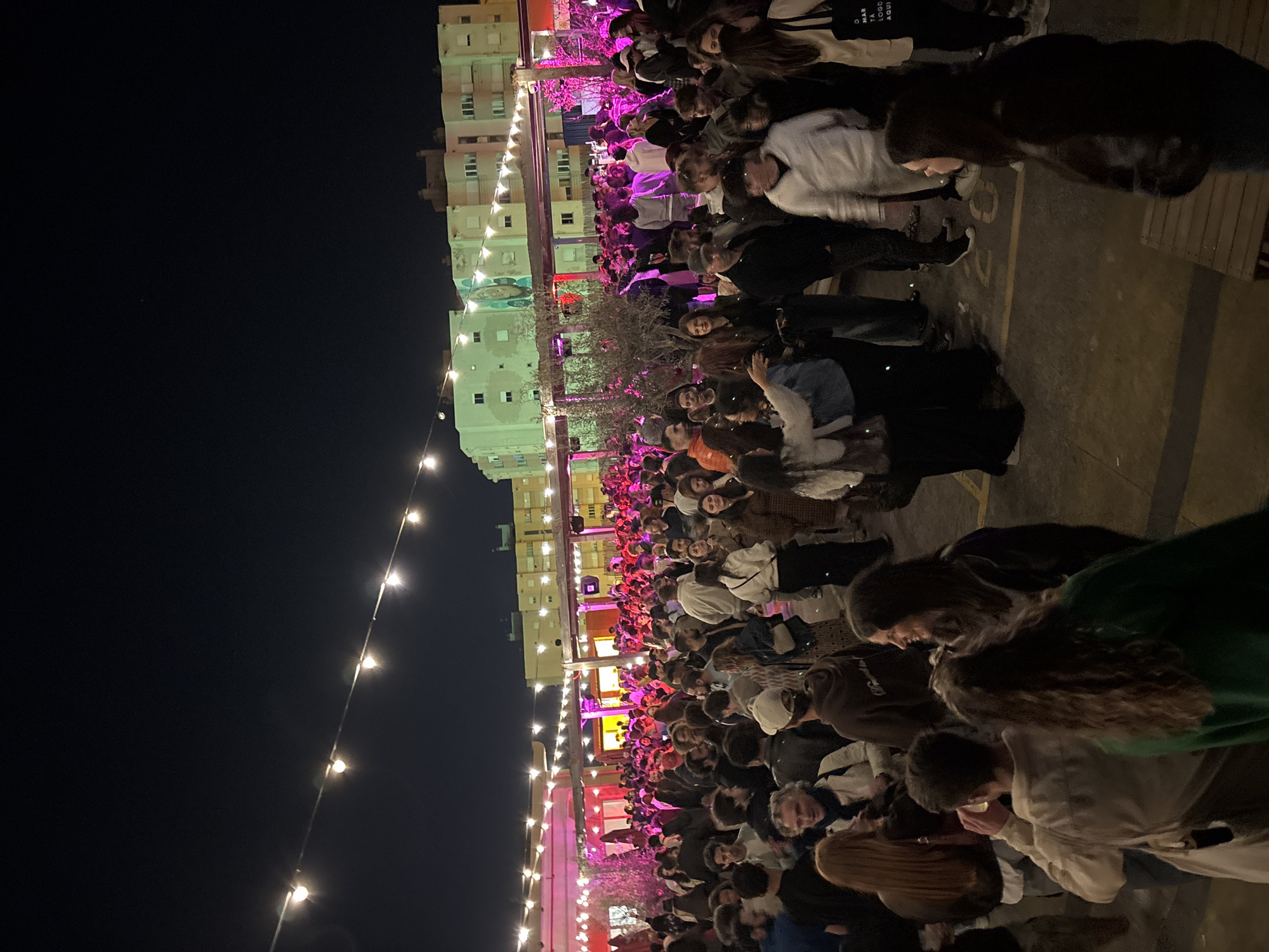 Large crowd gathers at nighttime outdoor venue in Lisbon