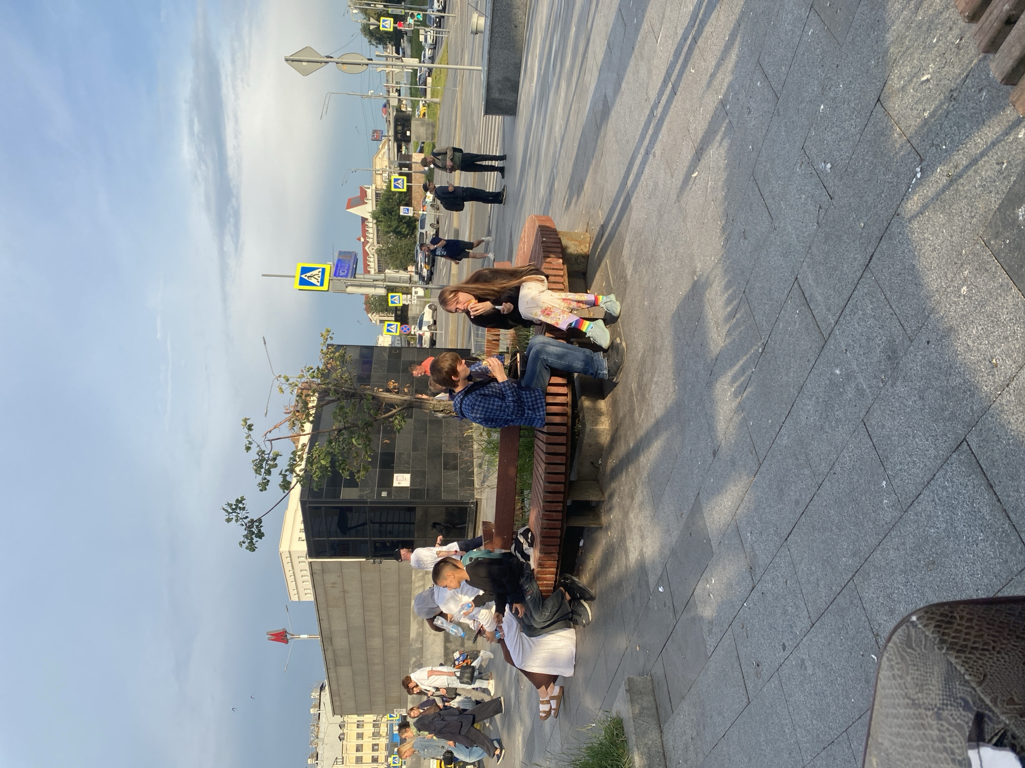 Afternoon life on a Moscow public plaza, pigeons and all