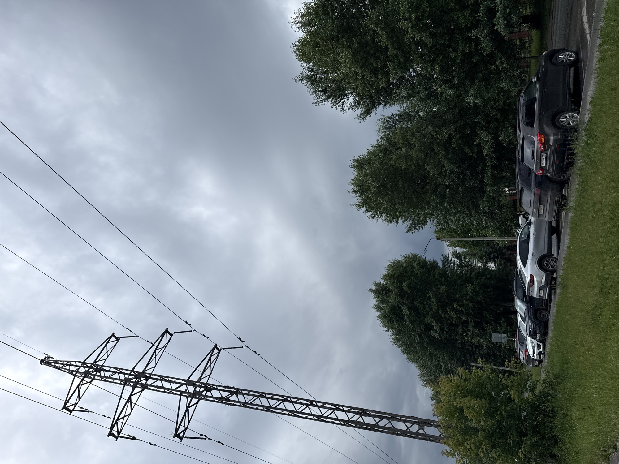 Power pylons and utility lines under a cloudy sky