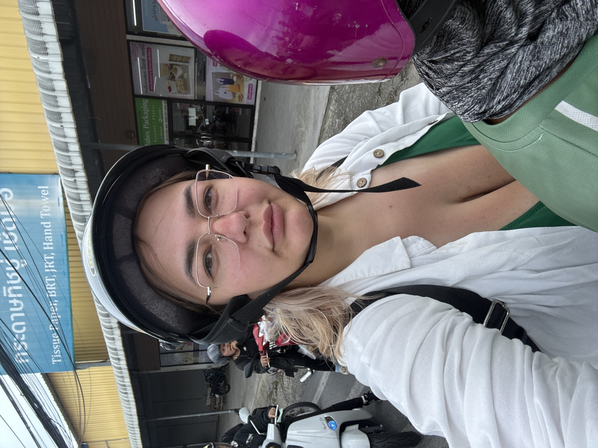 Riding through Karon's streets past shops and hillside housing