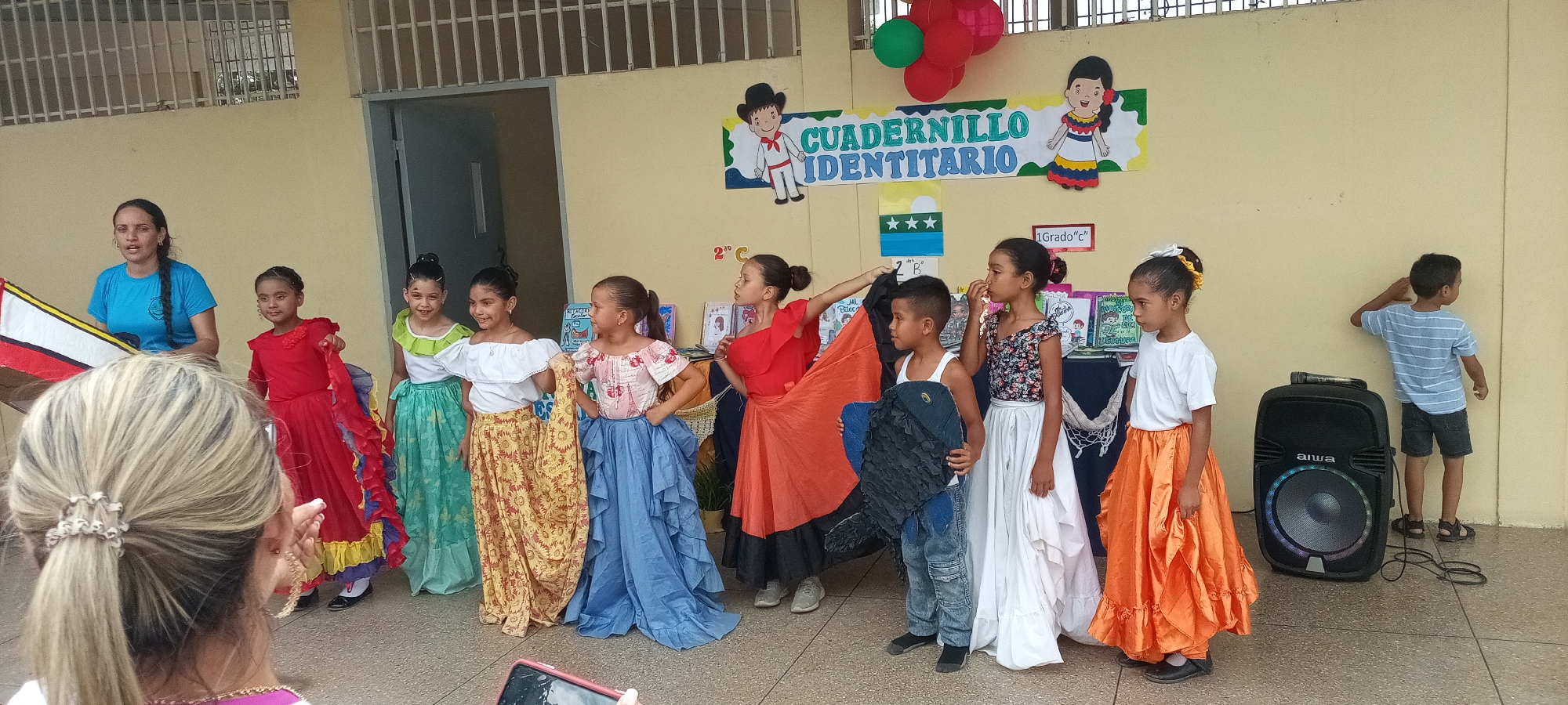 Children in traditional costumes gather for cultural school event