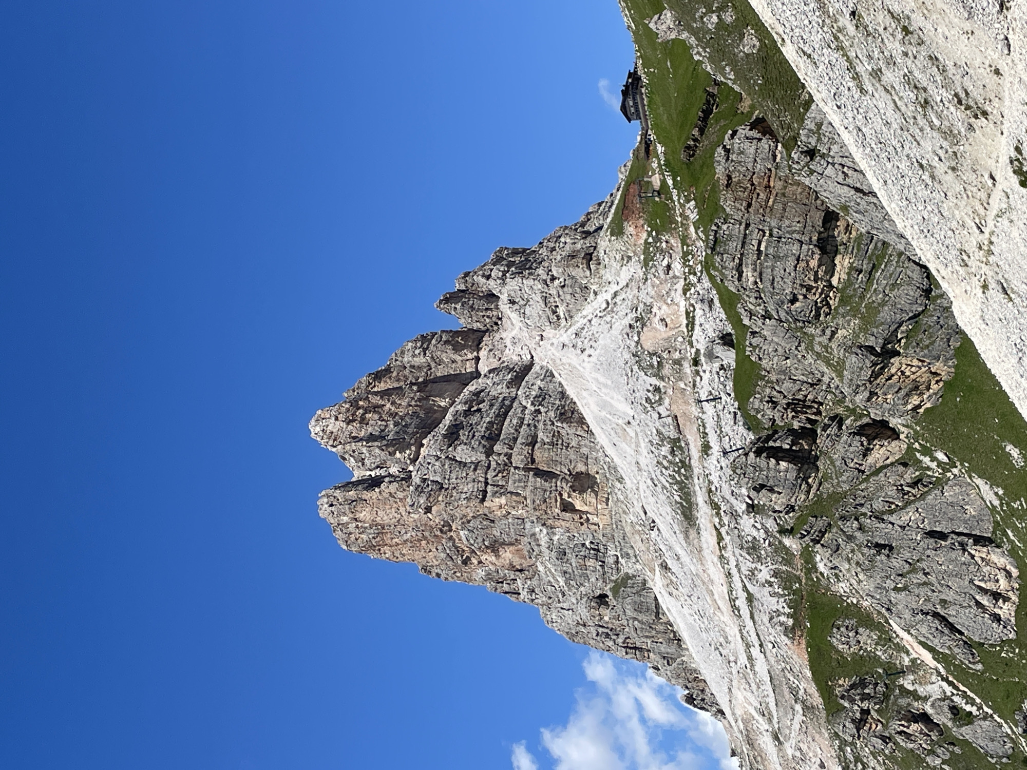 Jagged Dolomite peak cuts into a cloudless sky above Colle Santa Lucia