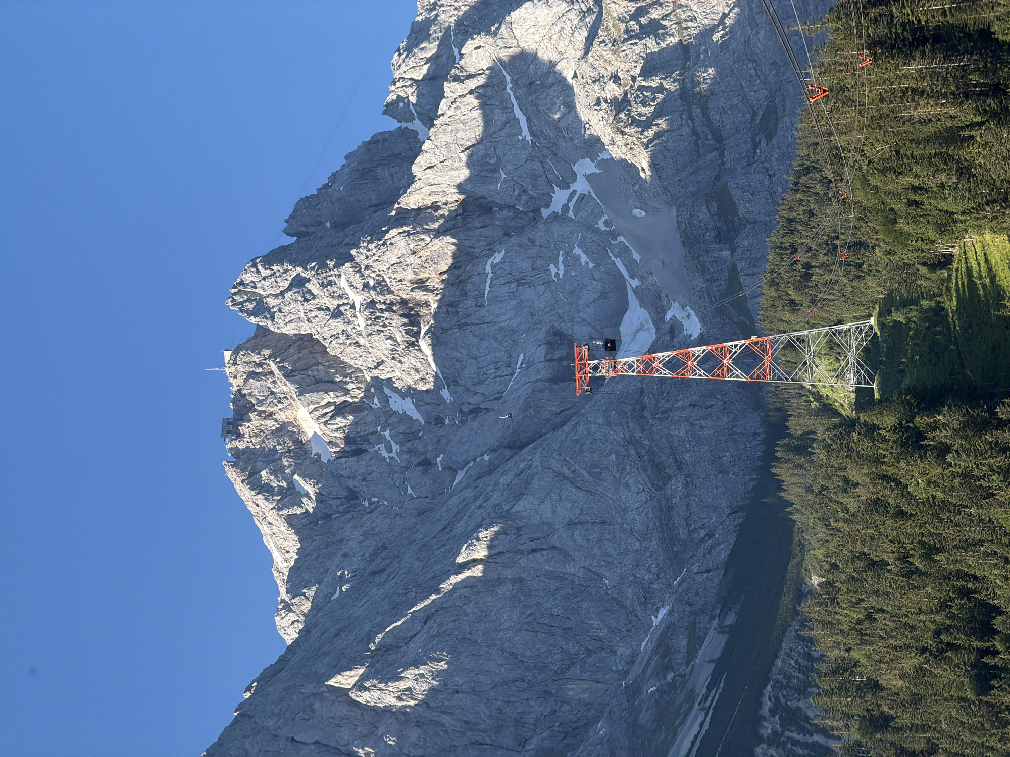 Cable car tower under blue skies in the Bavarian Alps