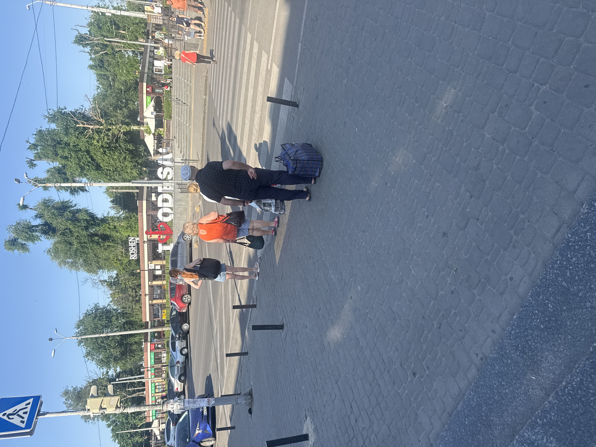 Sunny day foot traffic near Odesa's iconic 'I Love Odesa' sign