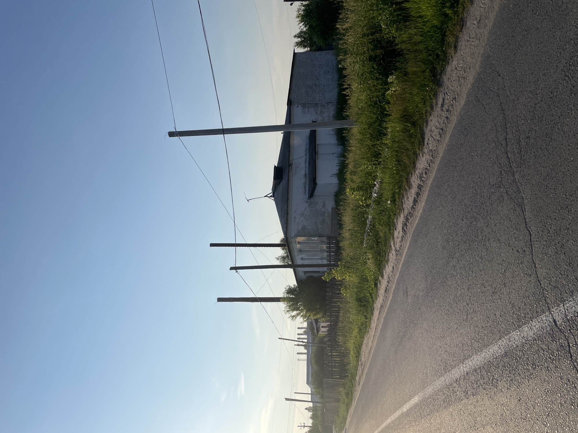 Drive through rural Russian village reveals mixed residential and industrial scenes
