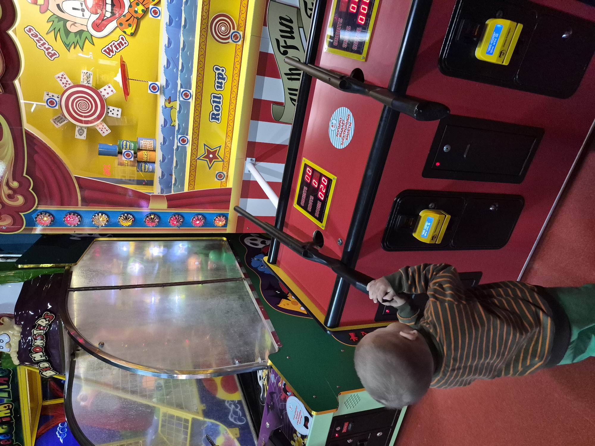Child plays arcade games at entertainment center in Tobolsk