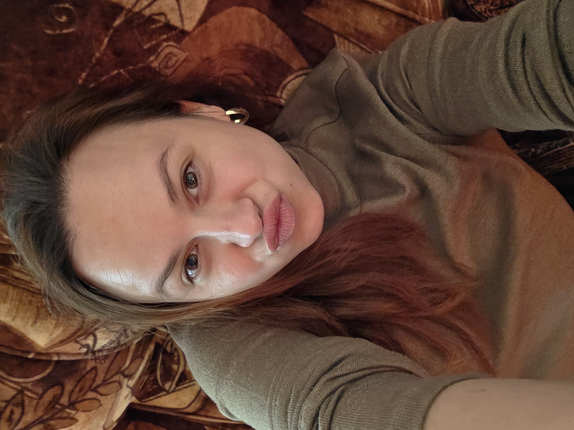 Woman photographed resting on couch in casual indoor setting
