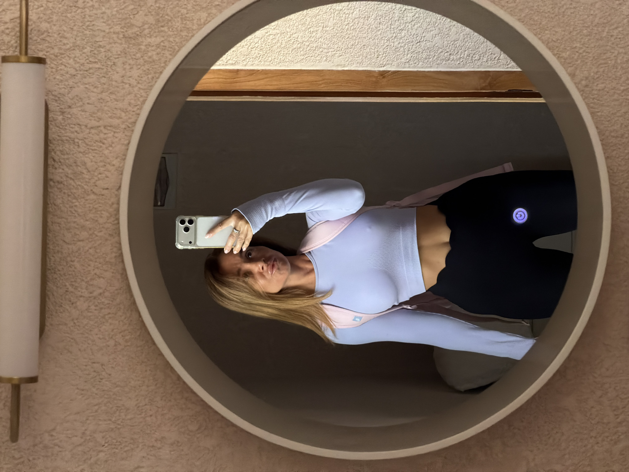 Mirror selfie in Mengwi bathroom, purple crop top and pink backpack