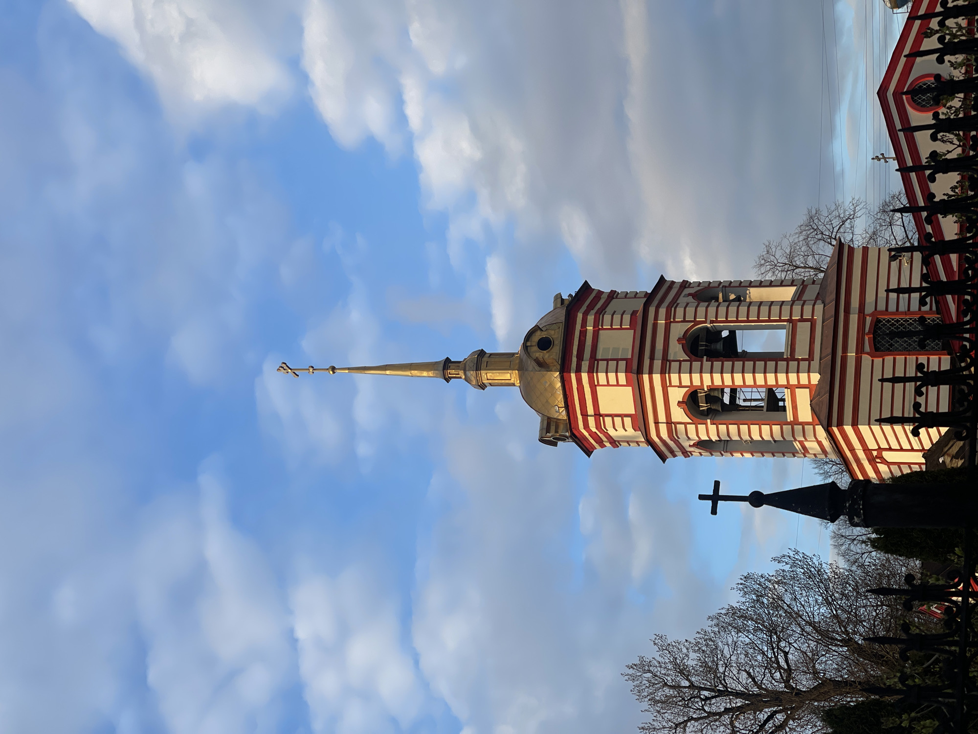 Striped church tower documented in Moscow under blue skies