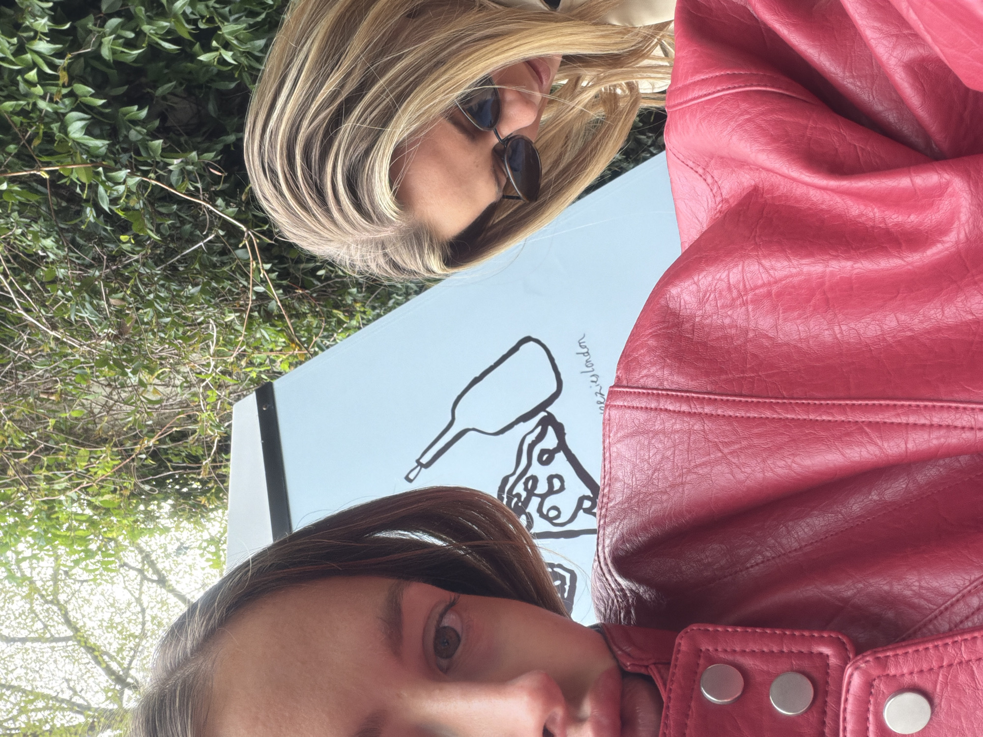Two women photographed near London restaurant and photo booth