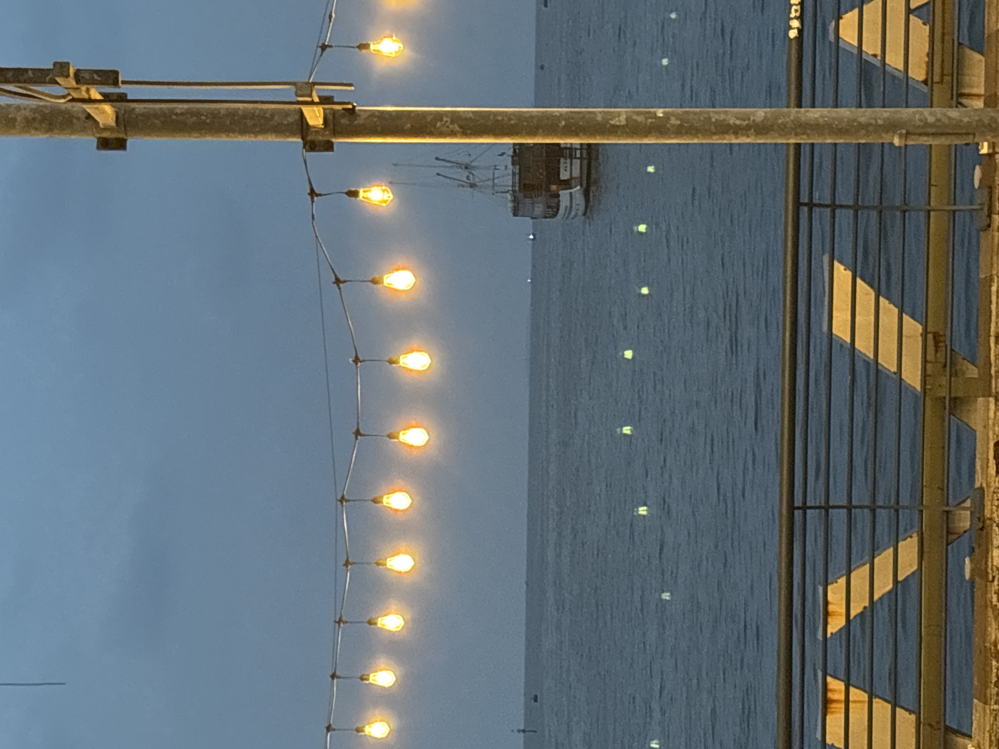 Evening stroll captured on illuminated Jakarta waterfront pier