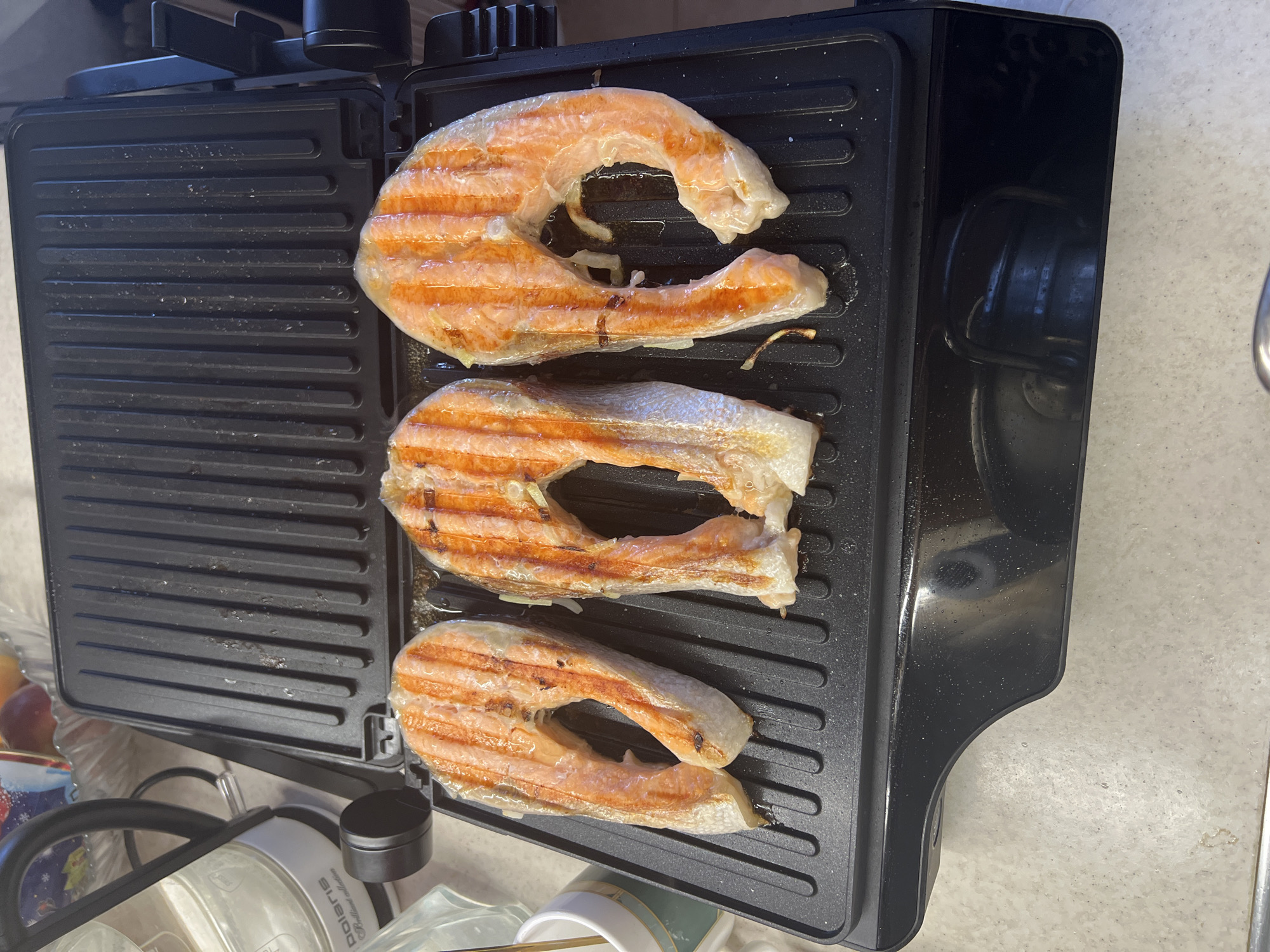 Moscow resident prepares grilled salmon lunch with vegetables