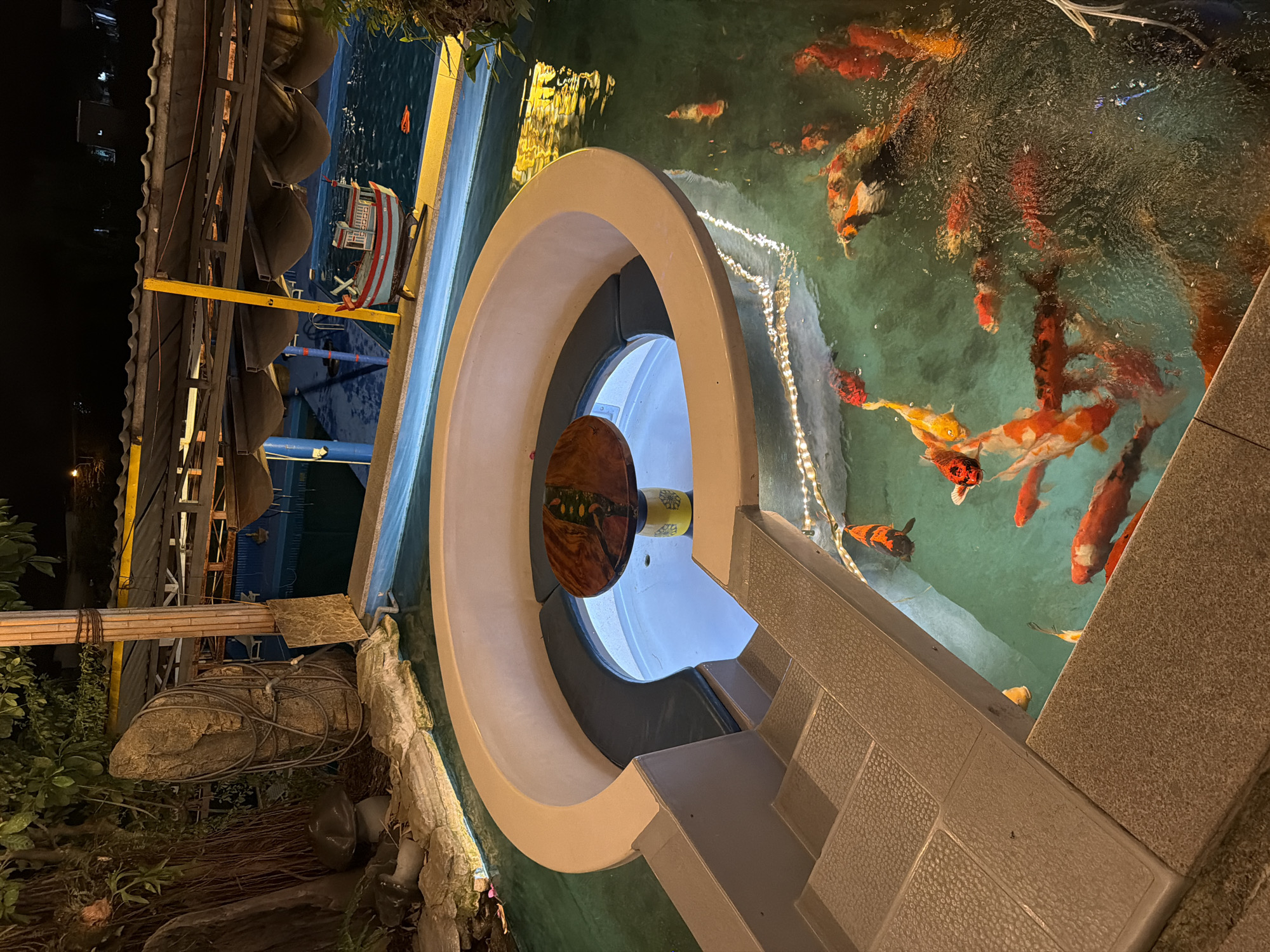Nighttime restaurant visit with koi pond and helicopter attraction