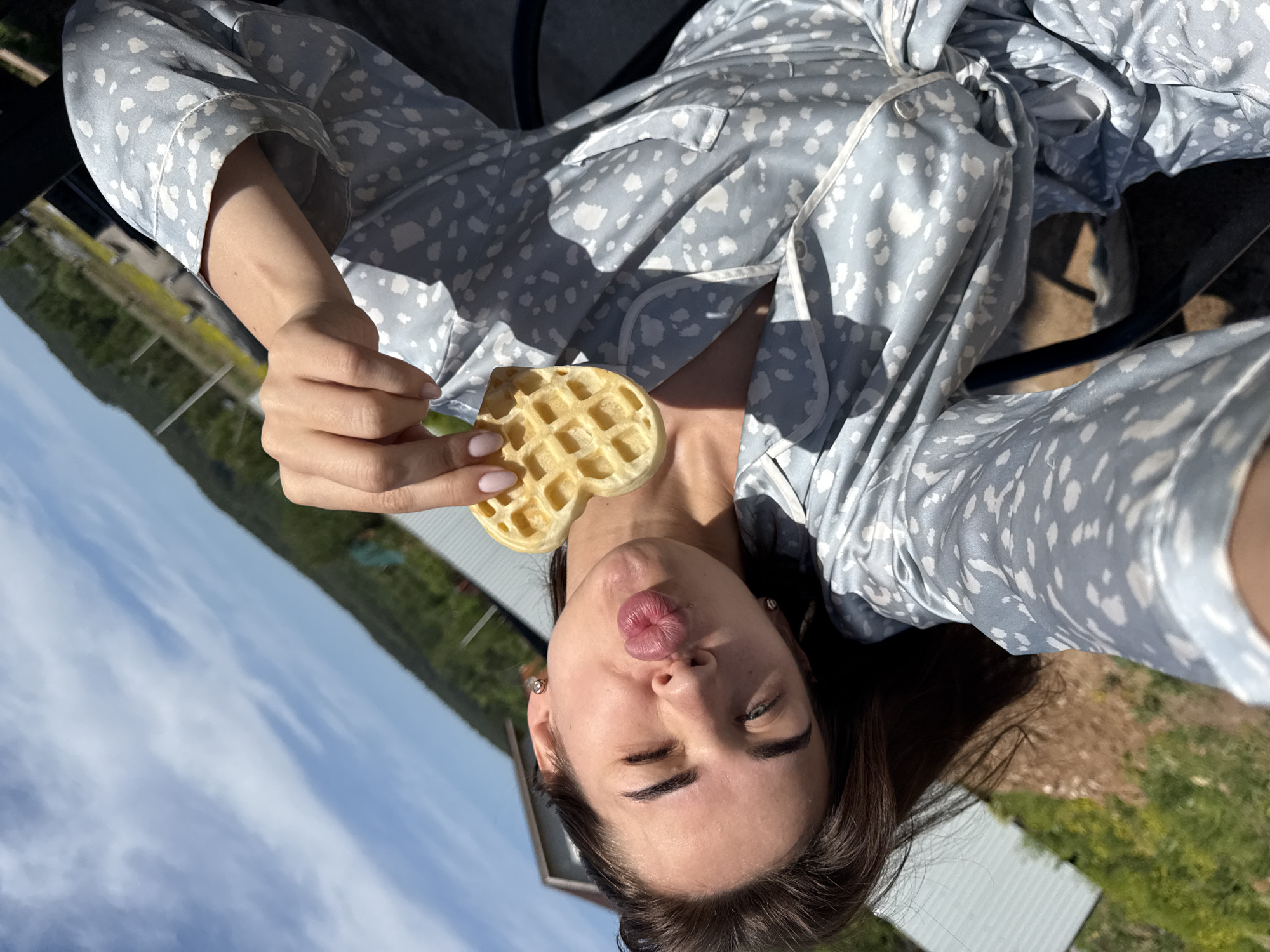 Woman takes waffle selfies during outdoor pajama breakfast