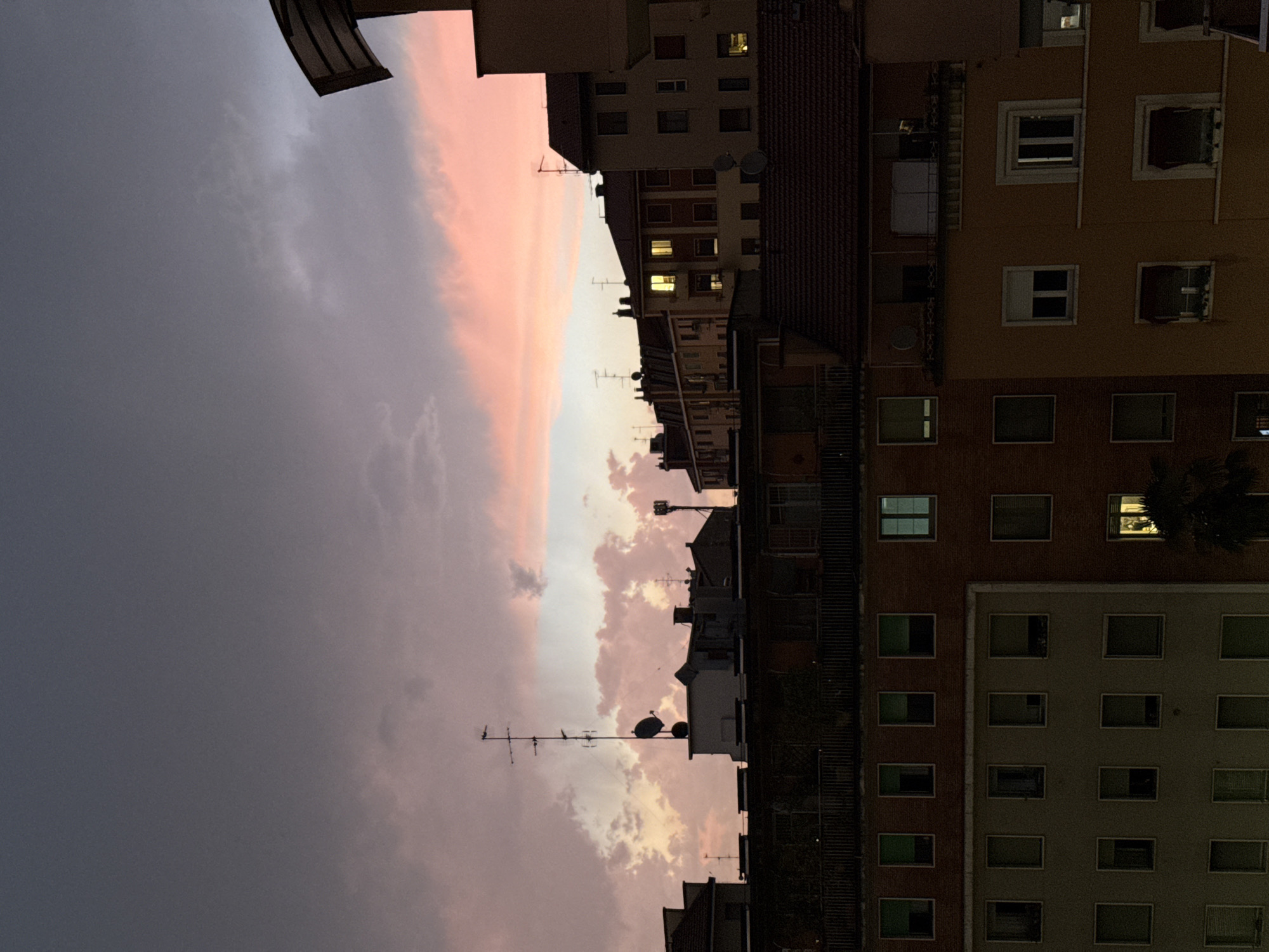 Dramatic sunset illuminates rainy Milan evening across multiple neighborhoods