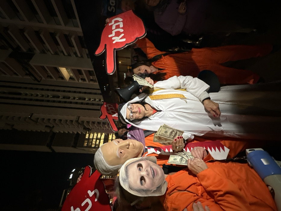 Nighttime protest with political masks, signs draws crowds in Tel Aviv