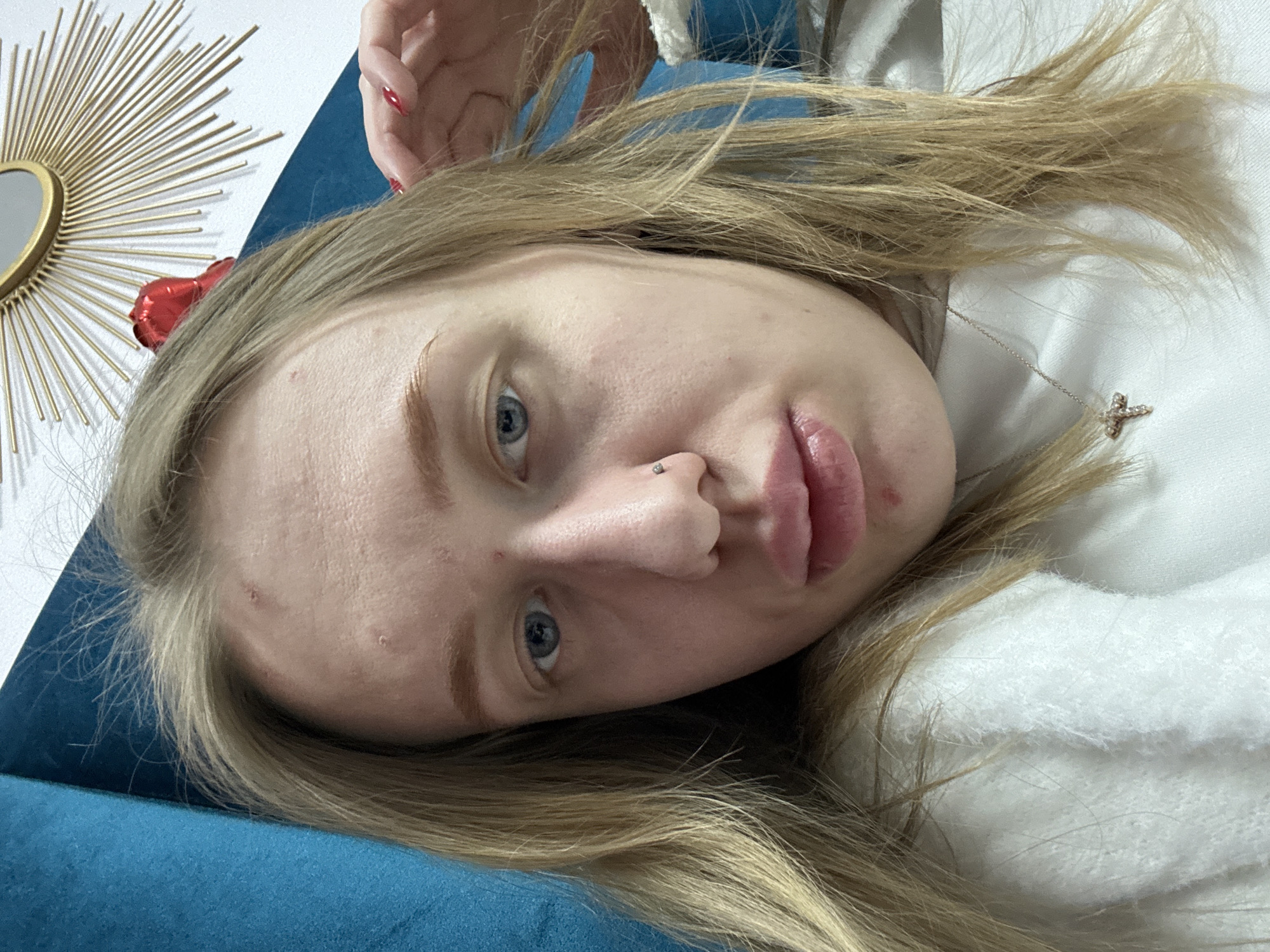 Woman photographed on blue couch in Rostov-on-Don apartment