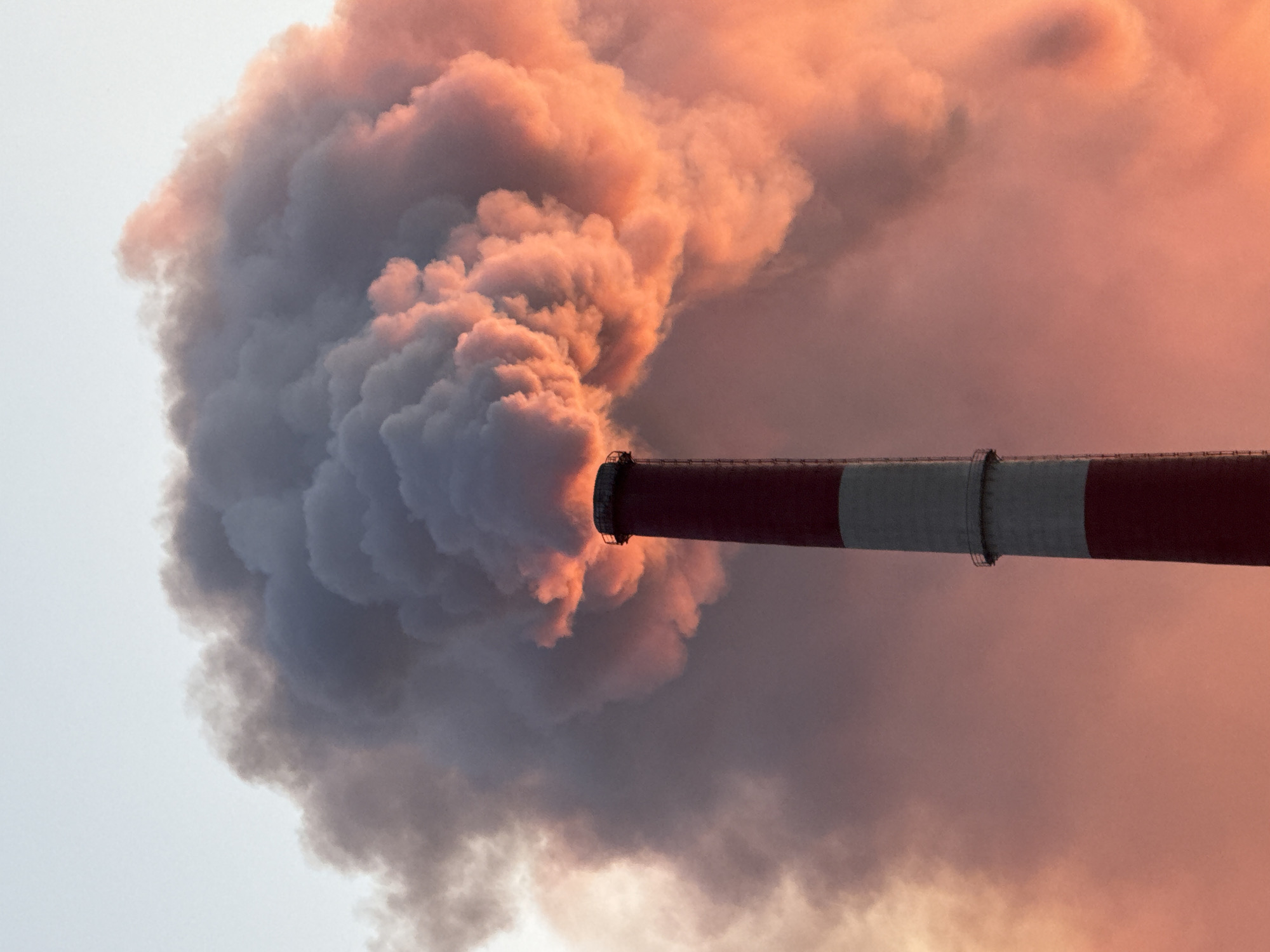 Norilsk smokestack belching smoke at sunset