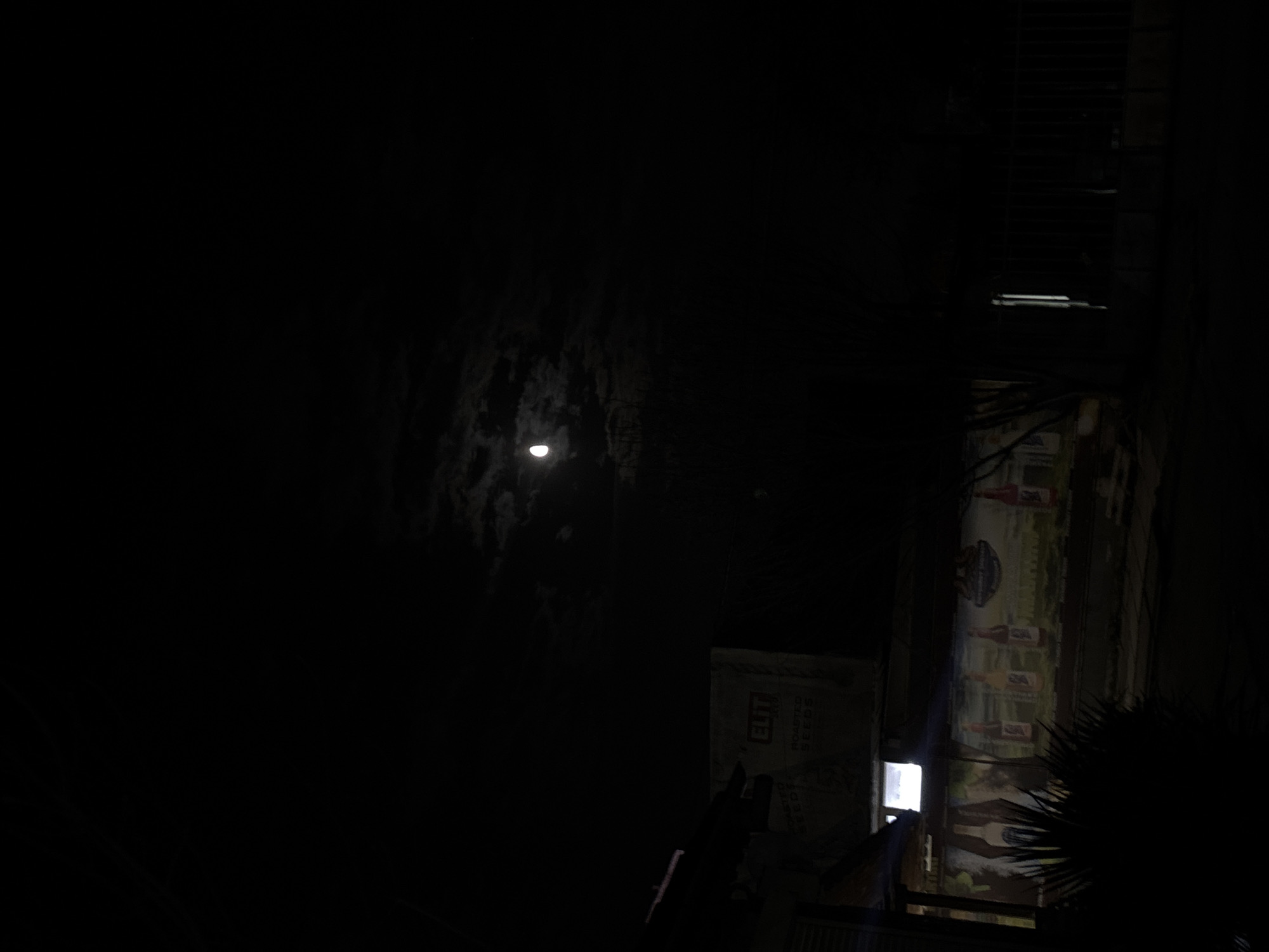 Full moon photographed over Varna building with bottle mural