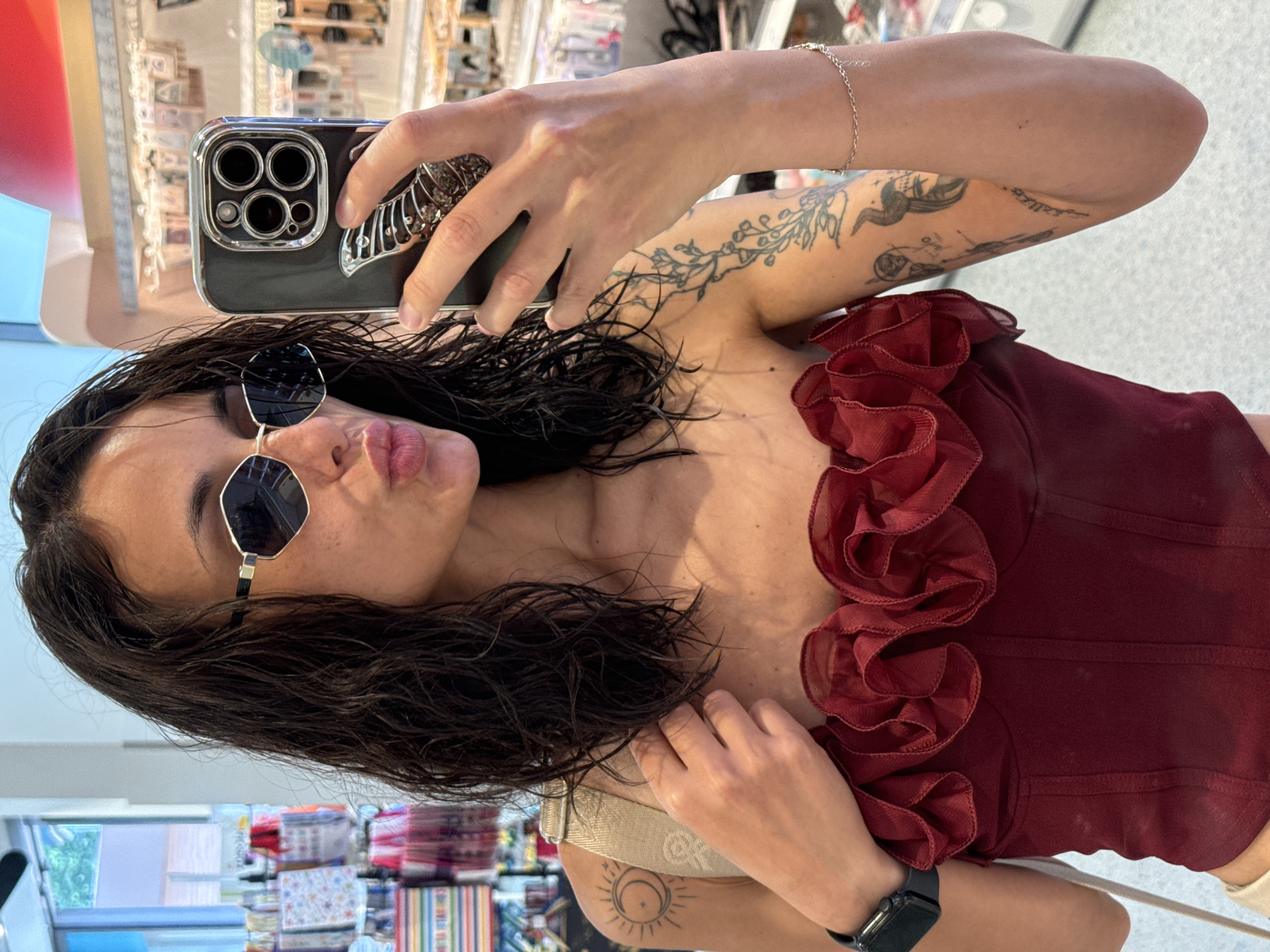 Woman takes selfies in Pleven wearing red top, sunglasses