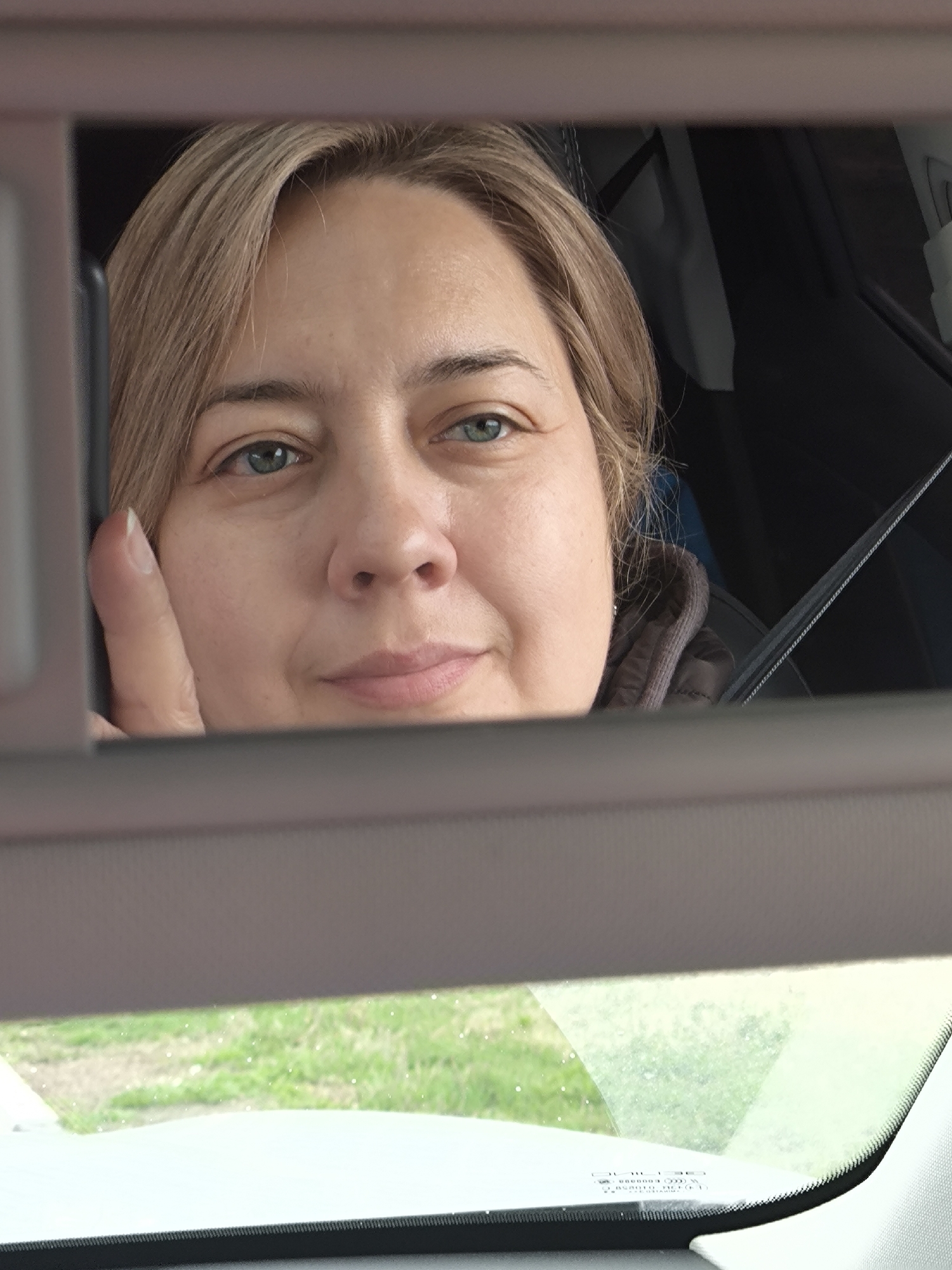Woman spotted smiling in car mirror reflection in Belkino
