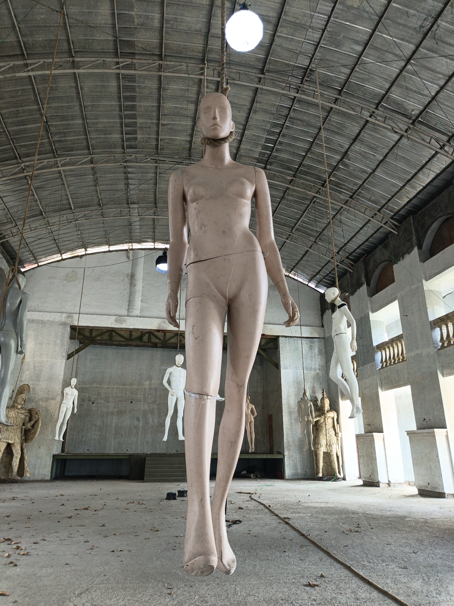 Mannequins suspended from warehouse ceiling in Cibogo, Indonesia