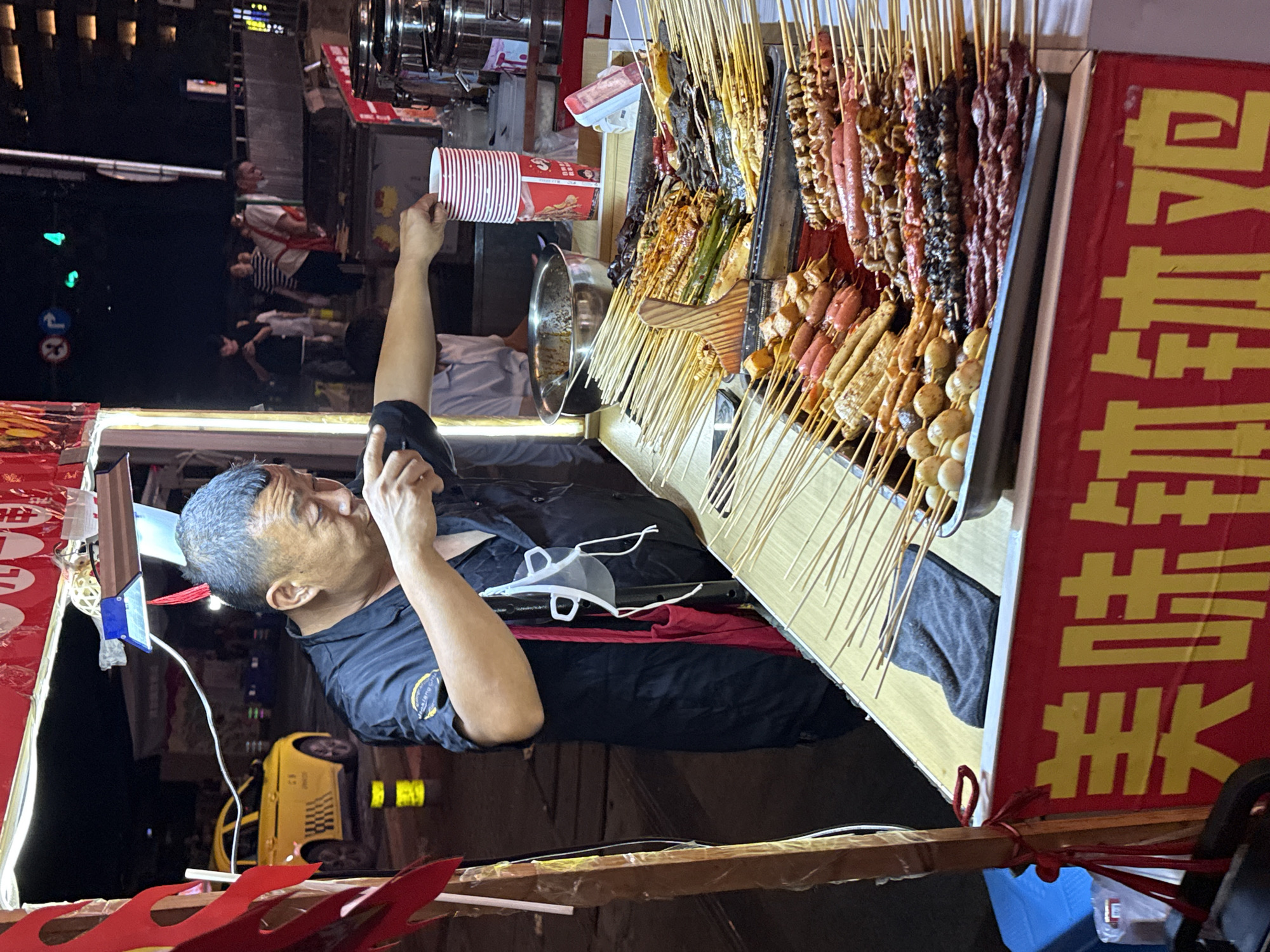 Night market activity along a lit traditional street in Shapingba