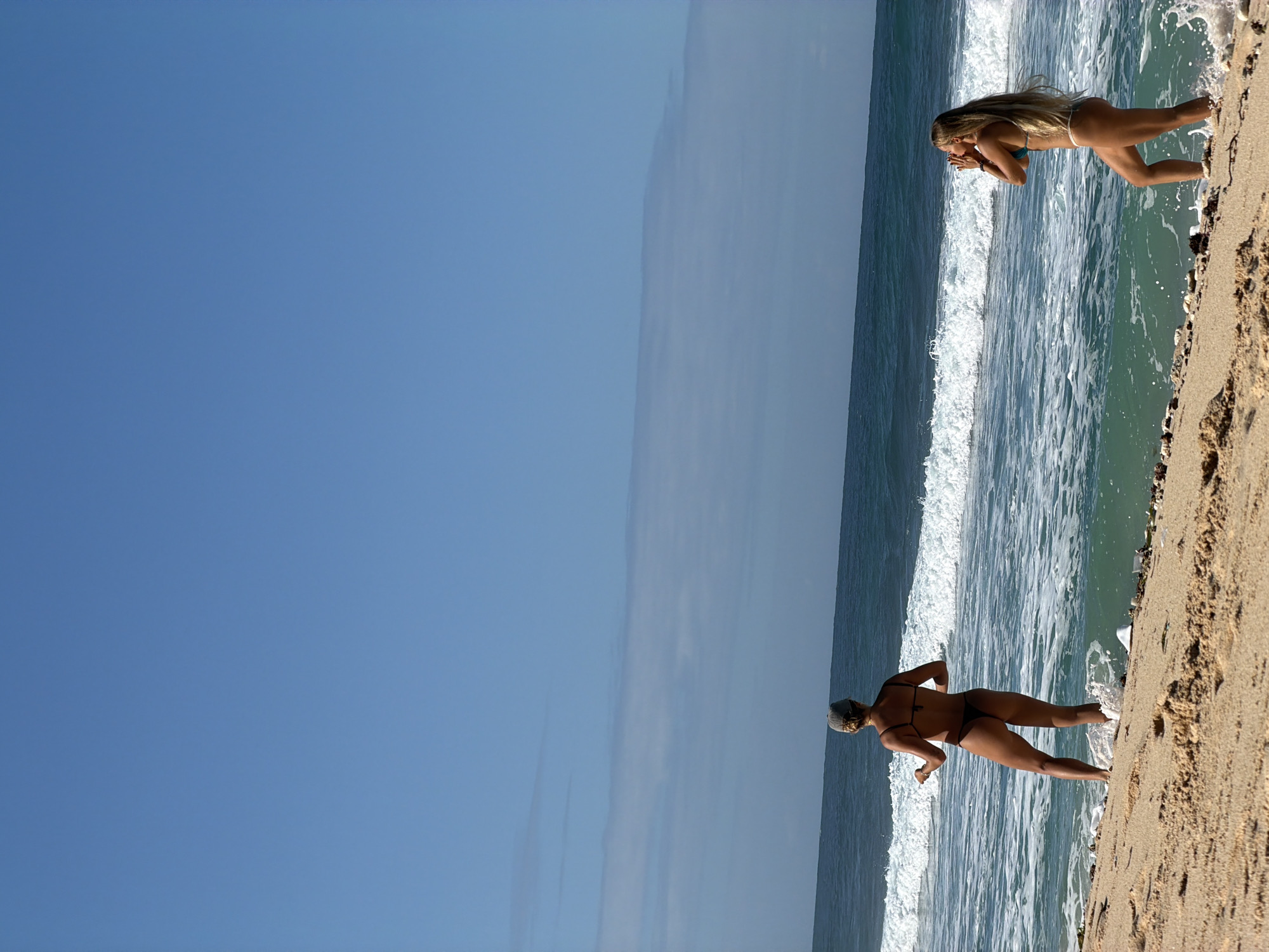 Two women enjoy beach time in Kuta Selatan