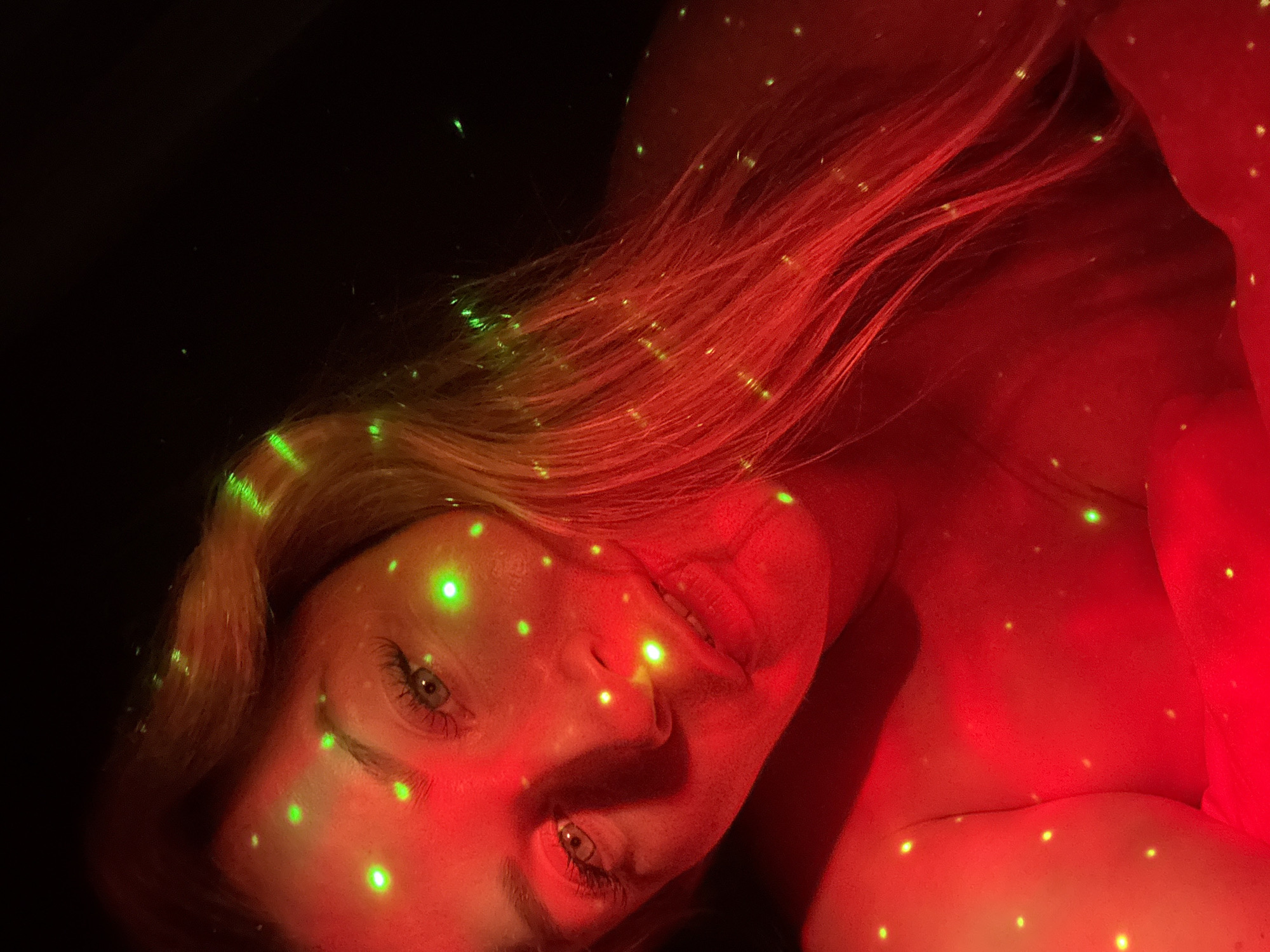 Portrait under red and green starry lights in Veliky Novgorod