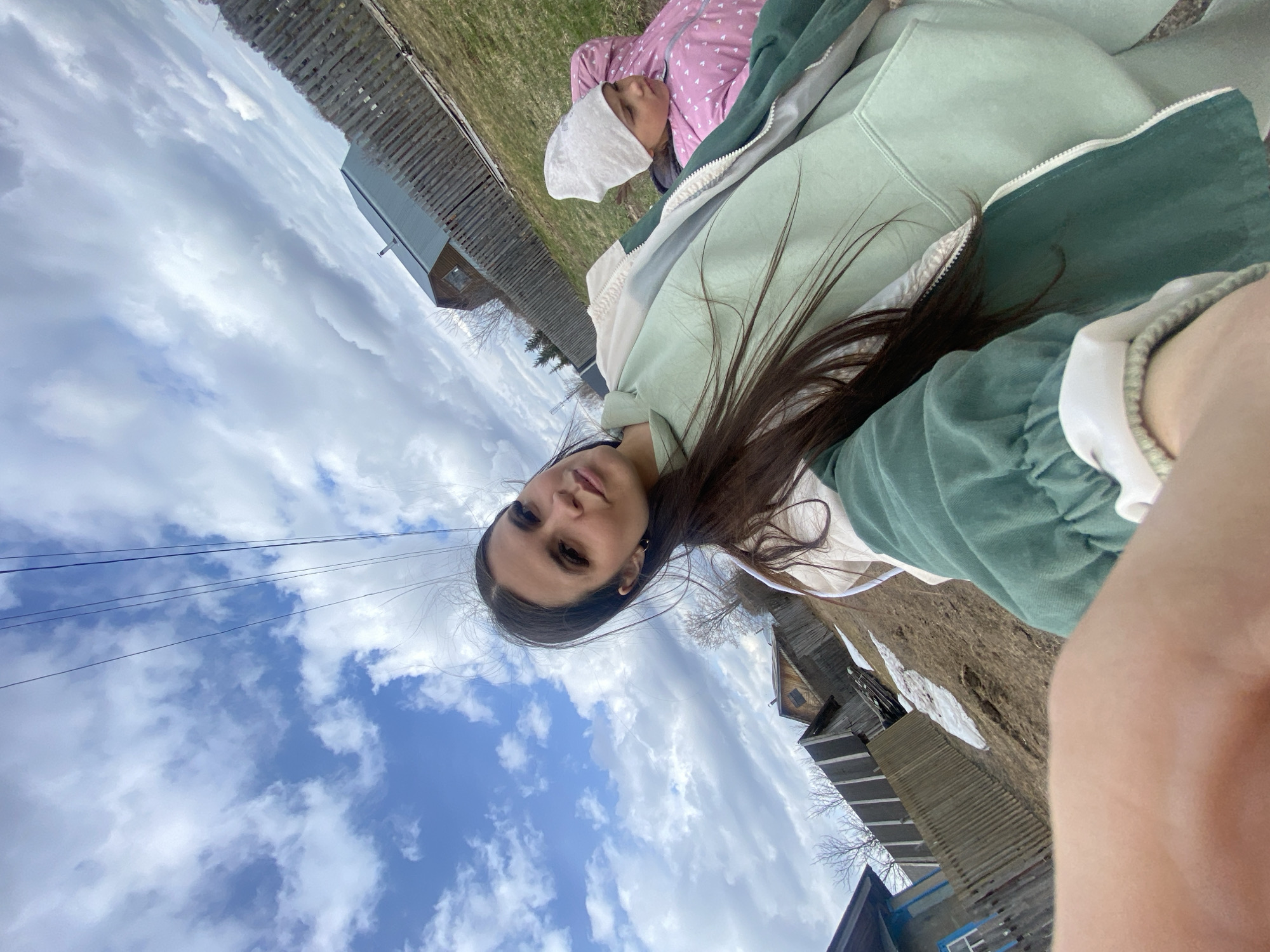 Woman takes selfie with child on rural road in Zhigalki