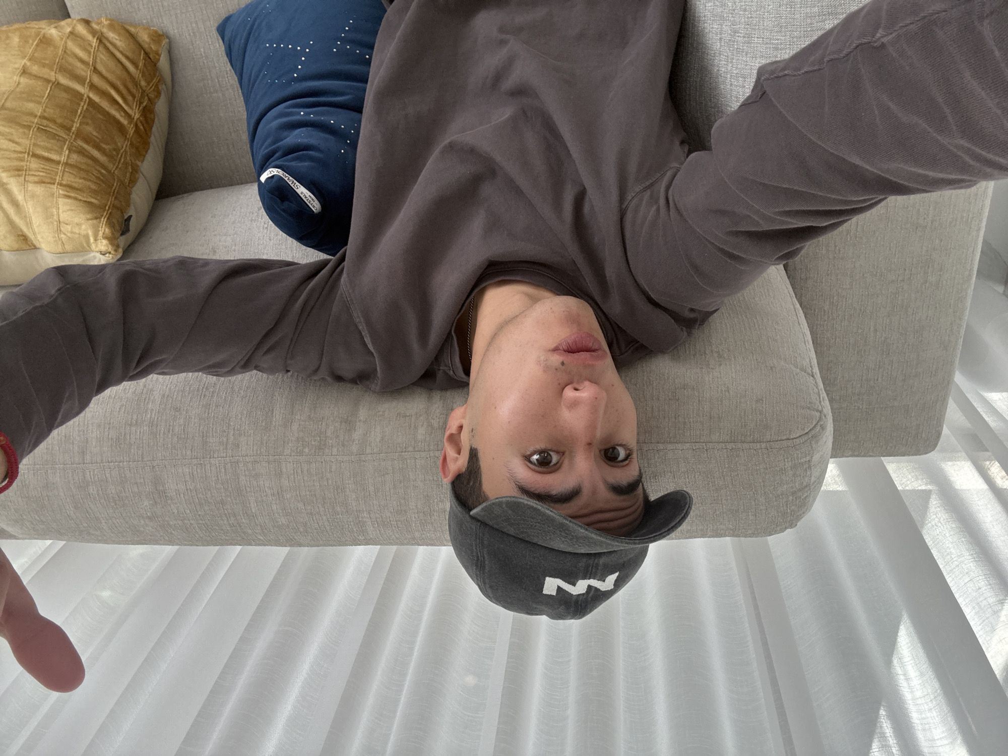 Person relaxes upside down on couch in Mexico home