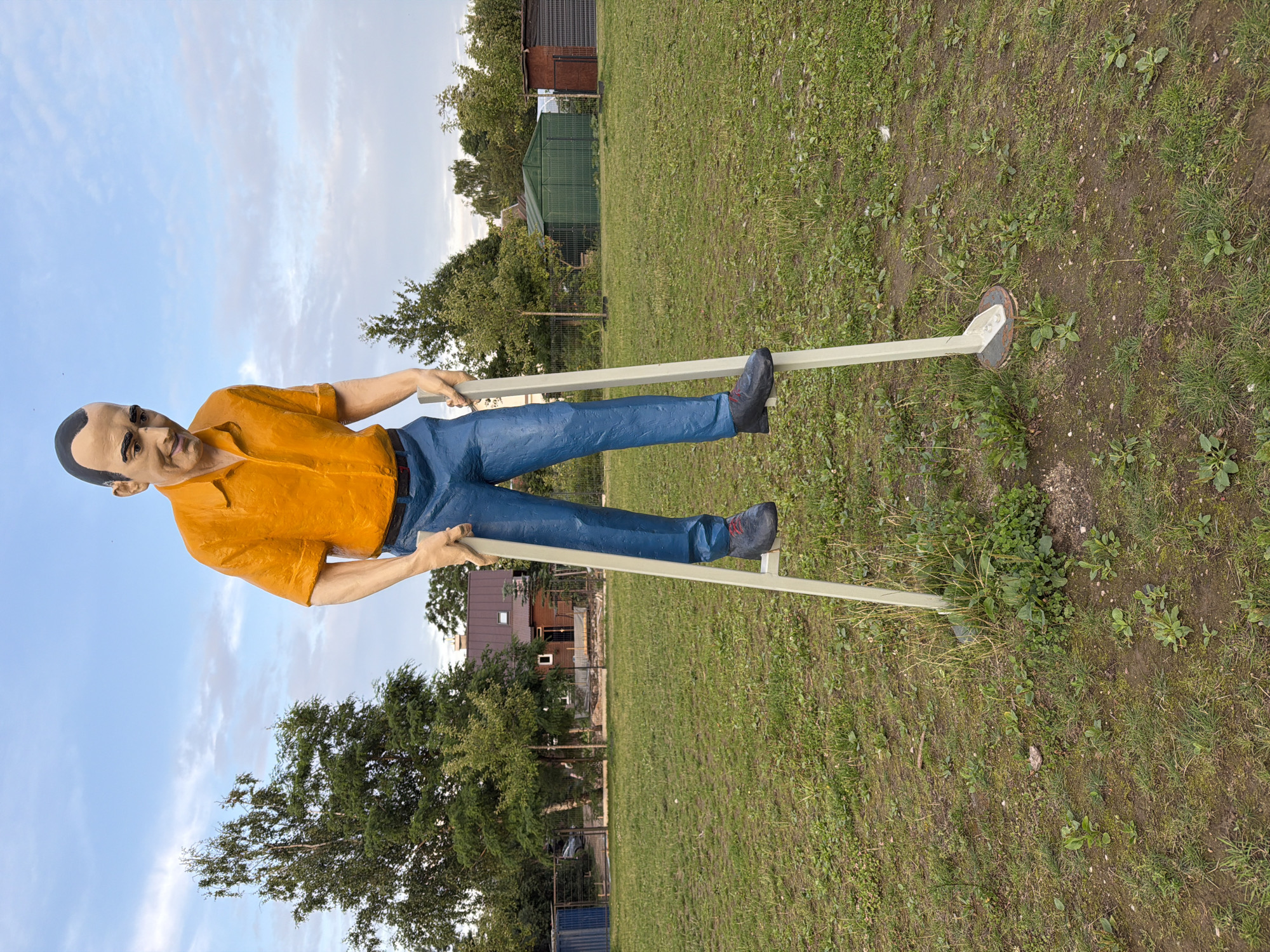 Stilt-mounted figural statues in an outdoor Vilnius setting