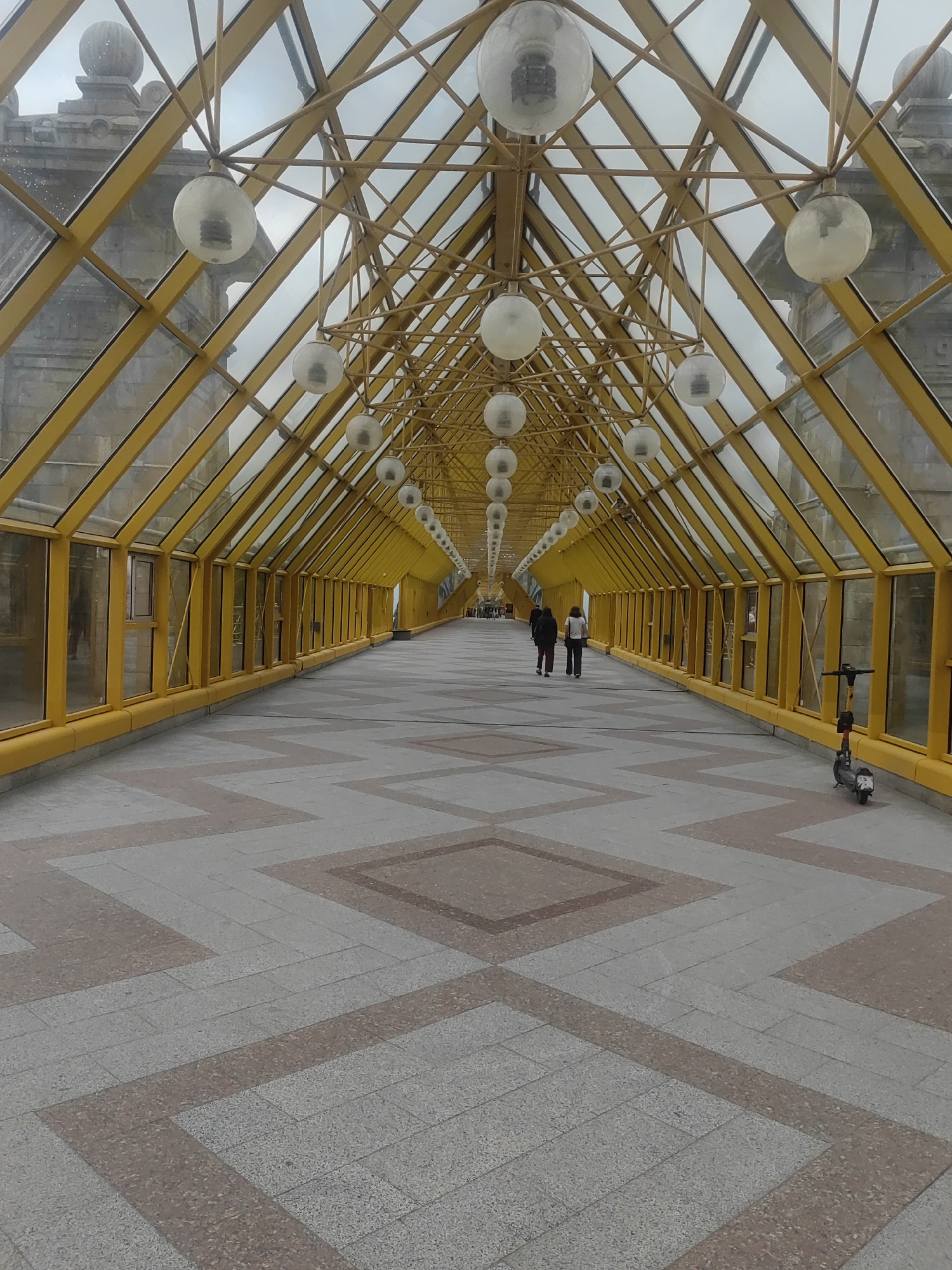 Moscow's yellow glass bridge and Moskva River on a grey afternoon