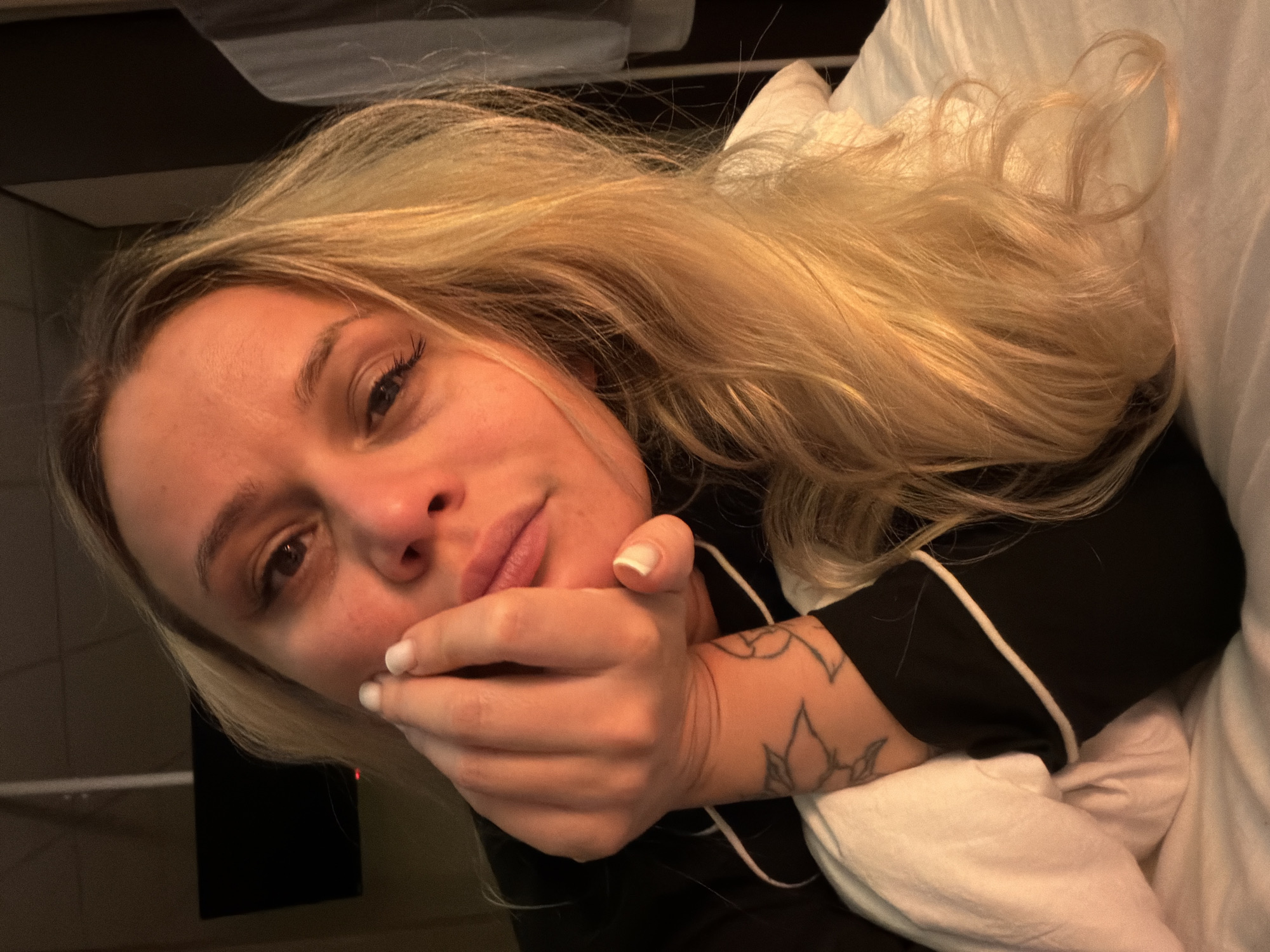 Woman takes multiple selfies indoors in Sarapul, Russia