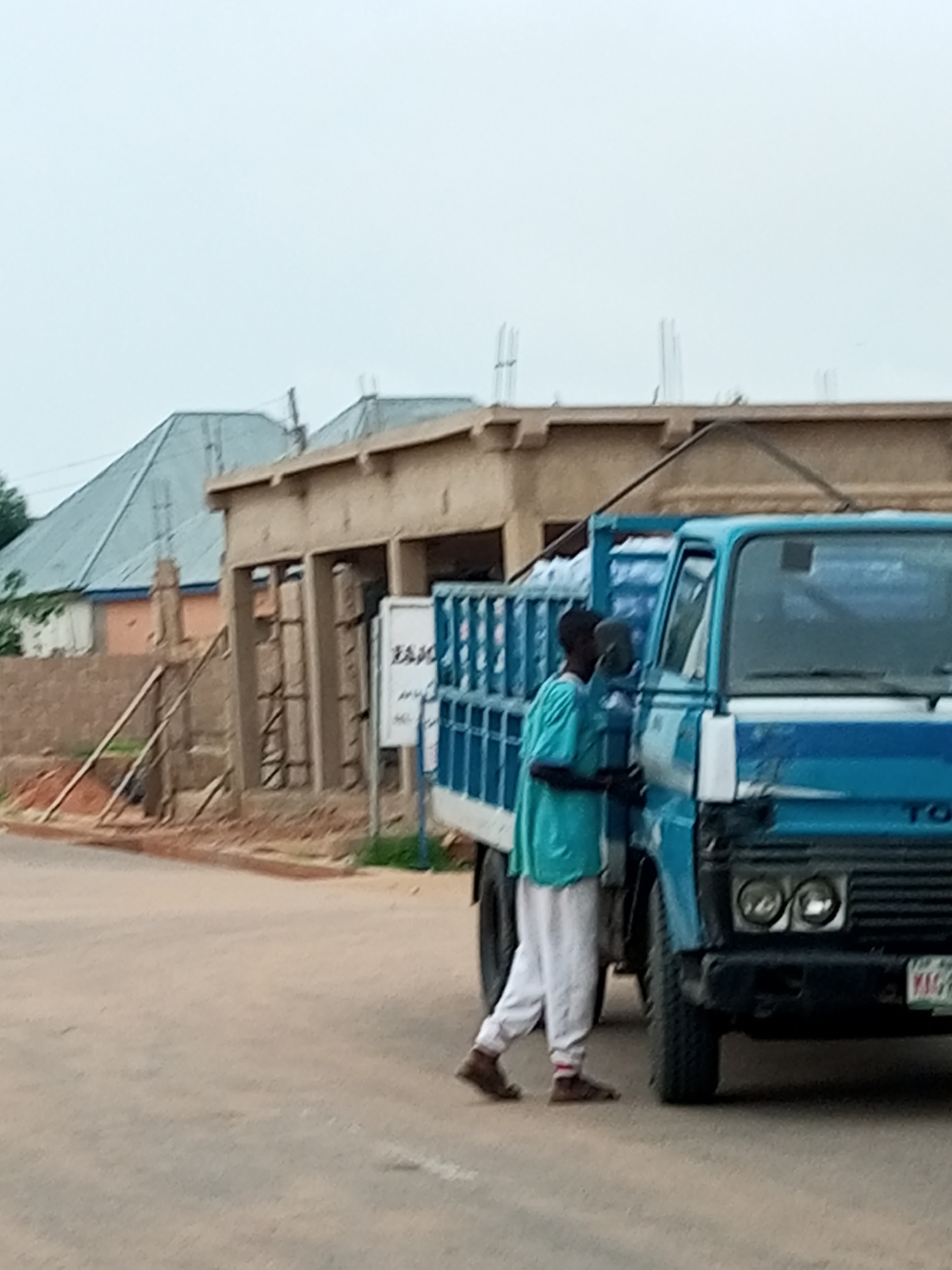 Walking alongside a loaded cargo truck on a paved road