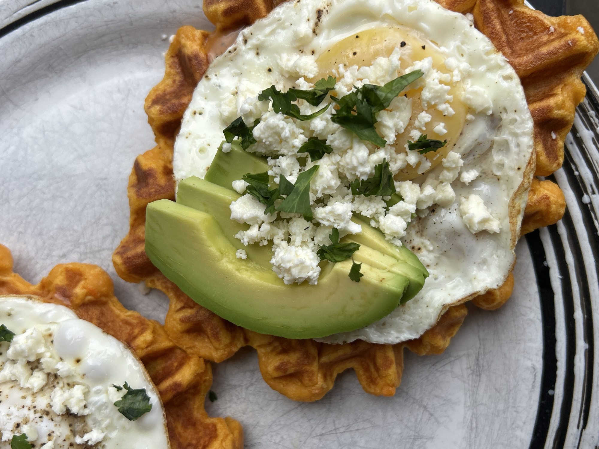 Woman prepares gourmet waffle dish in Whistler kitchen