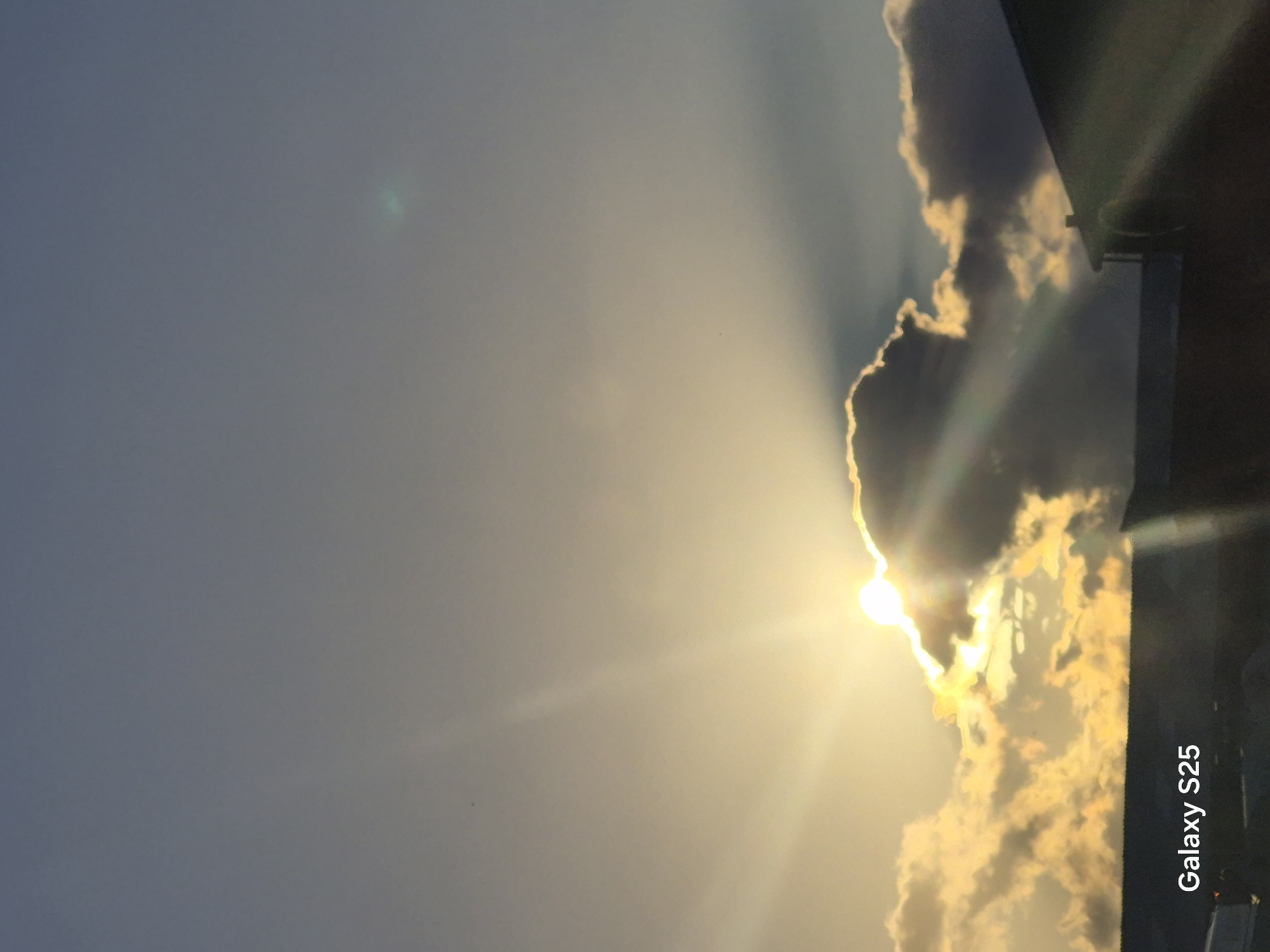 Crepuscular rays break through storm clouds at Pątnów sunset