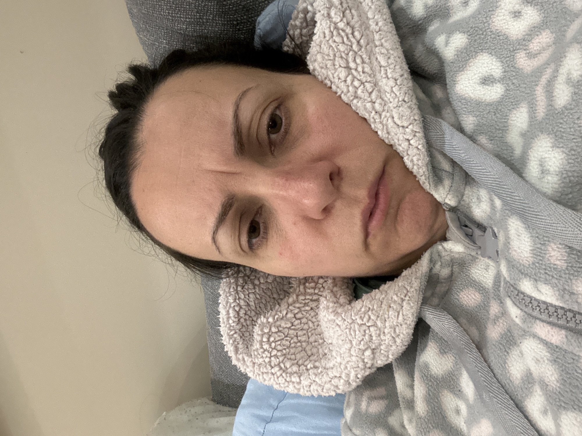 Woman rests in bed at home in Sofia