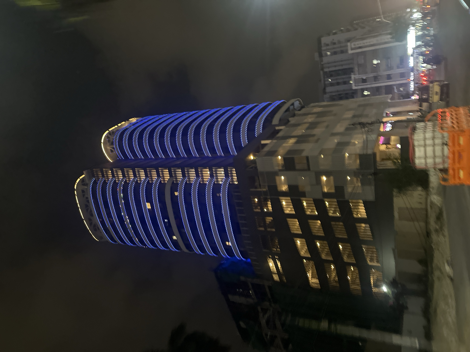 Arumina Tower glows in blue and yellow against Karachi's night sky